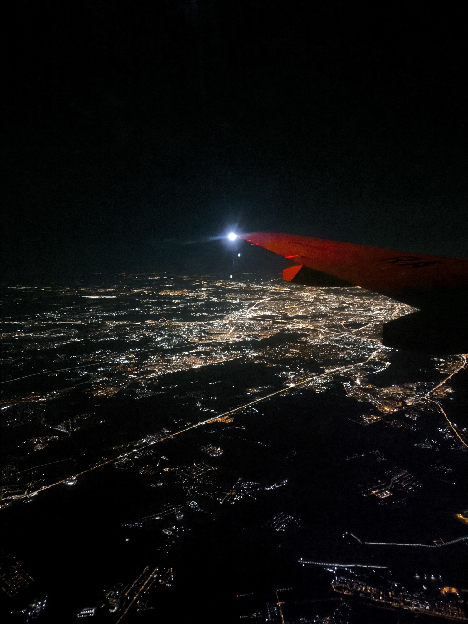 Nighttime aerial view of Khimki cityscape from airplane