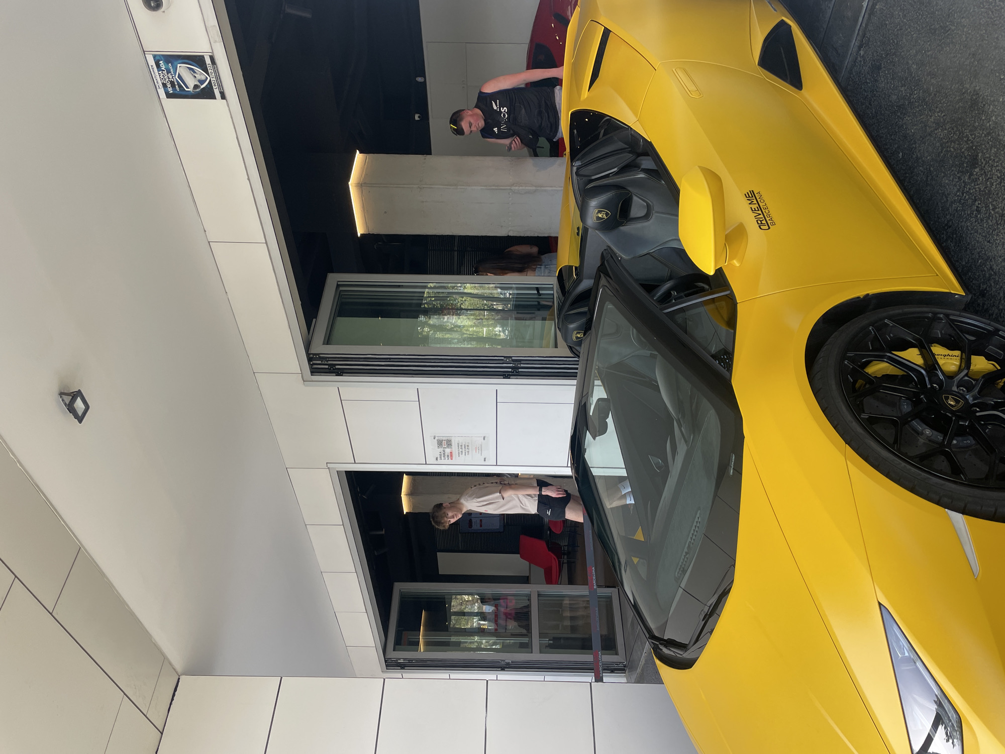 Luxury car gathering documented at Barcelona dealership Friday afternoon