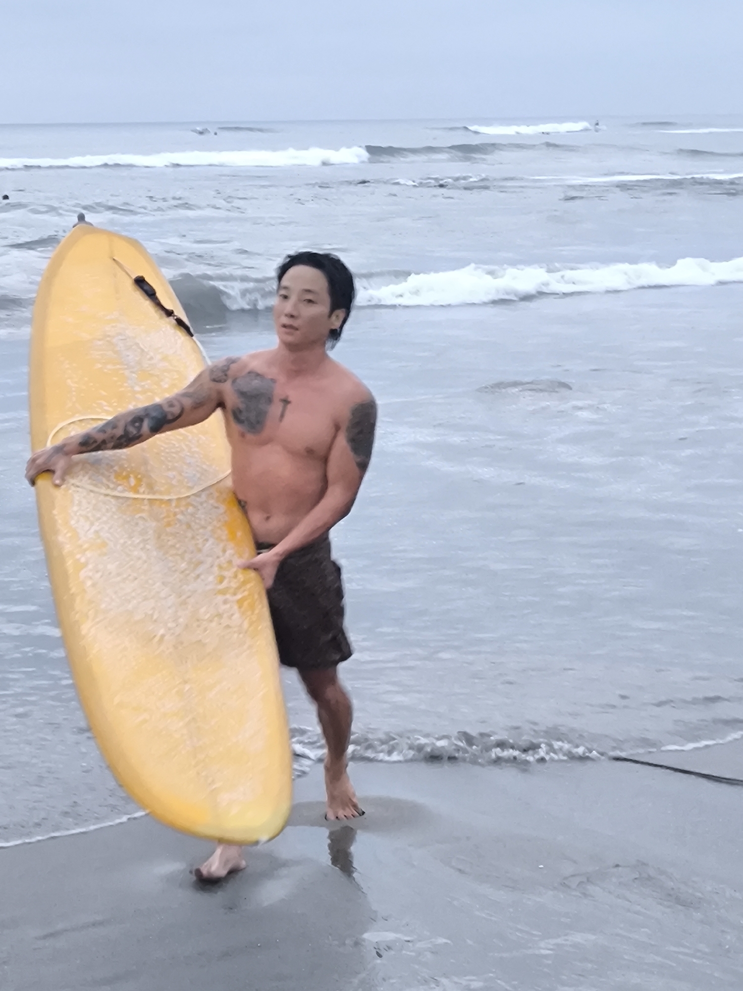 Surfer with yellow board spotted on Canggu beach