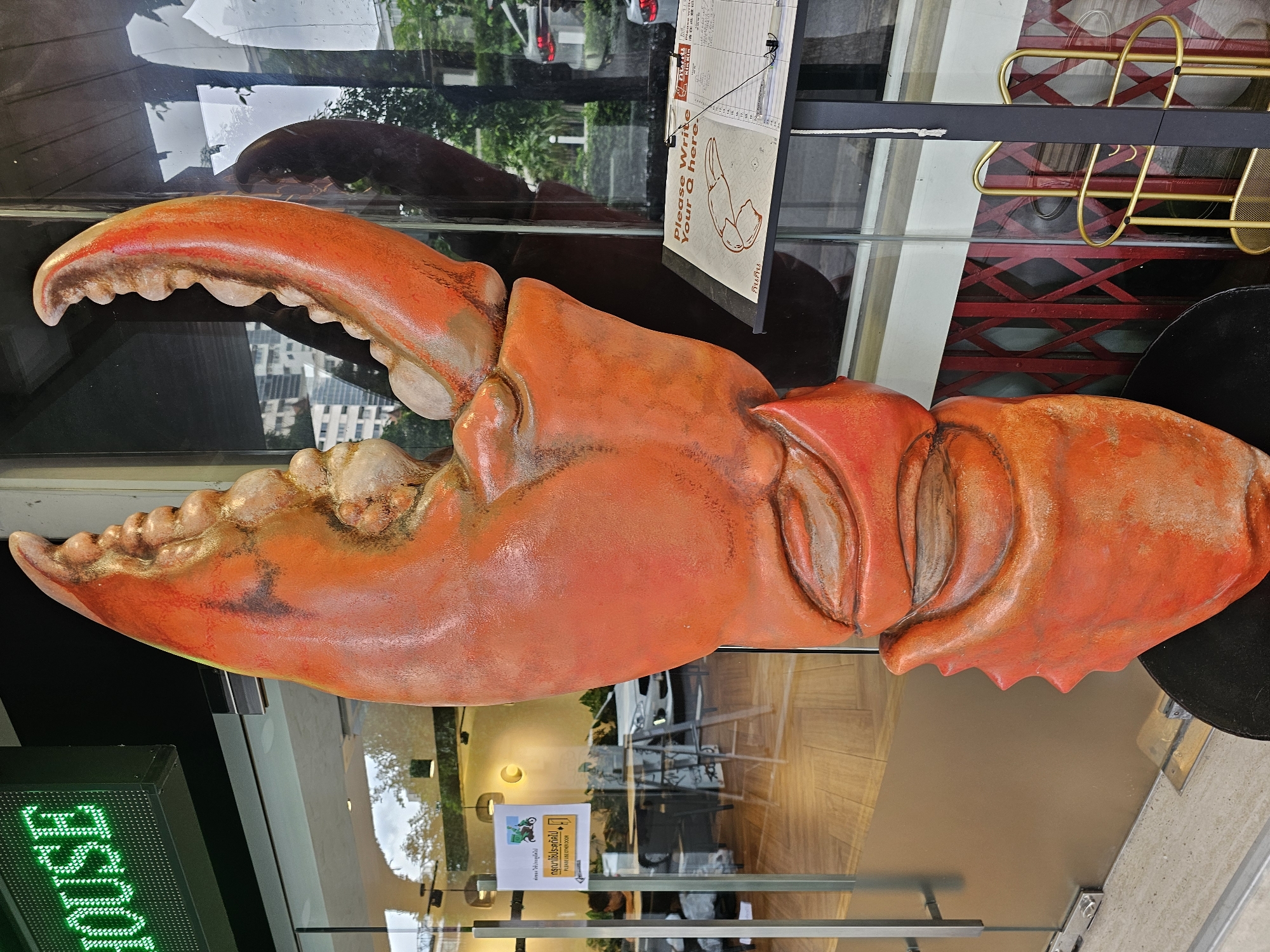 Bangkok block with boutiques, a playscape, and a giant crab claw