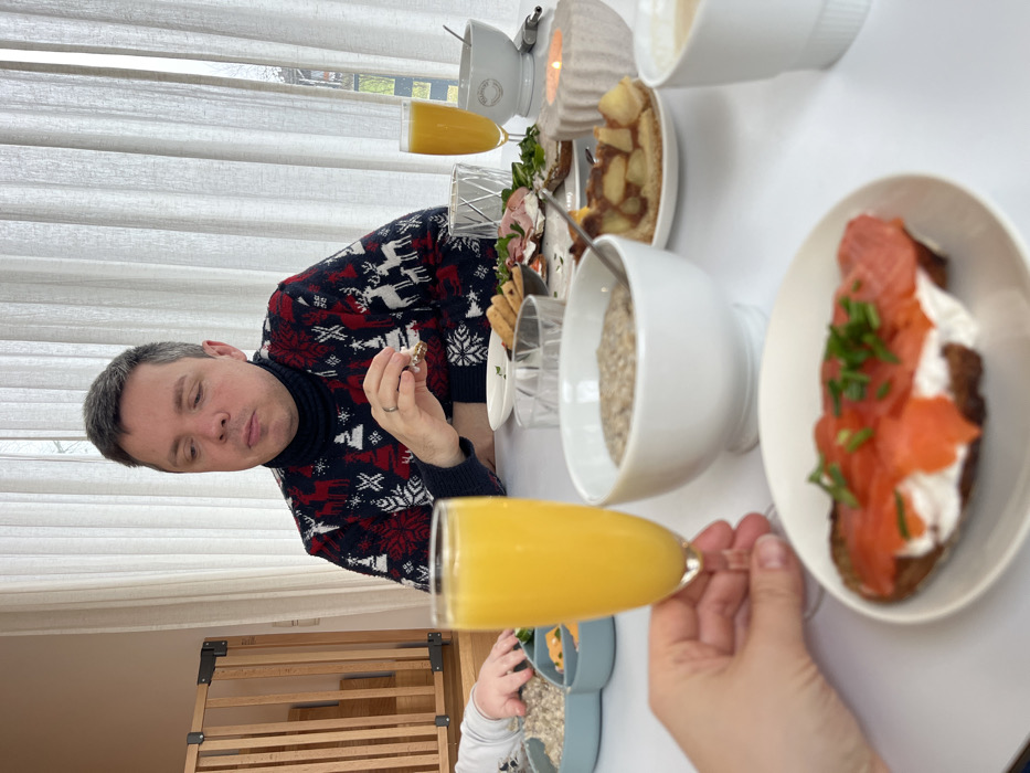 German Family Documents Morning Routine with Infant and Corgi