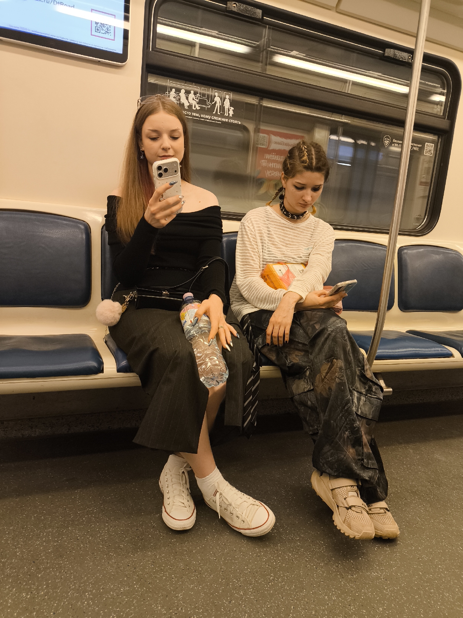 Subway riders and a sling-carried dog on transit