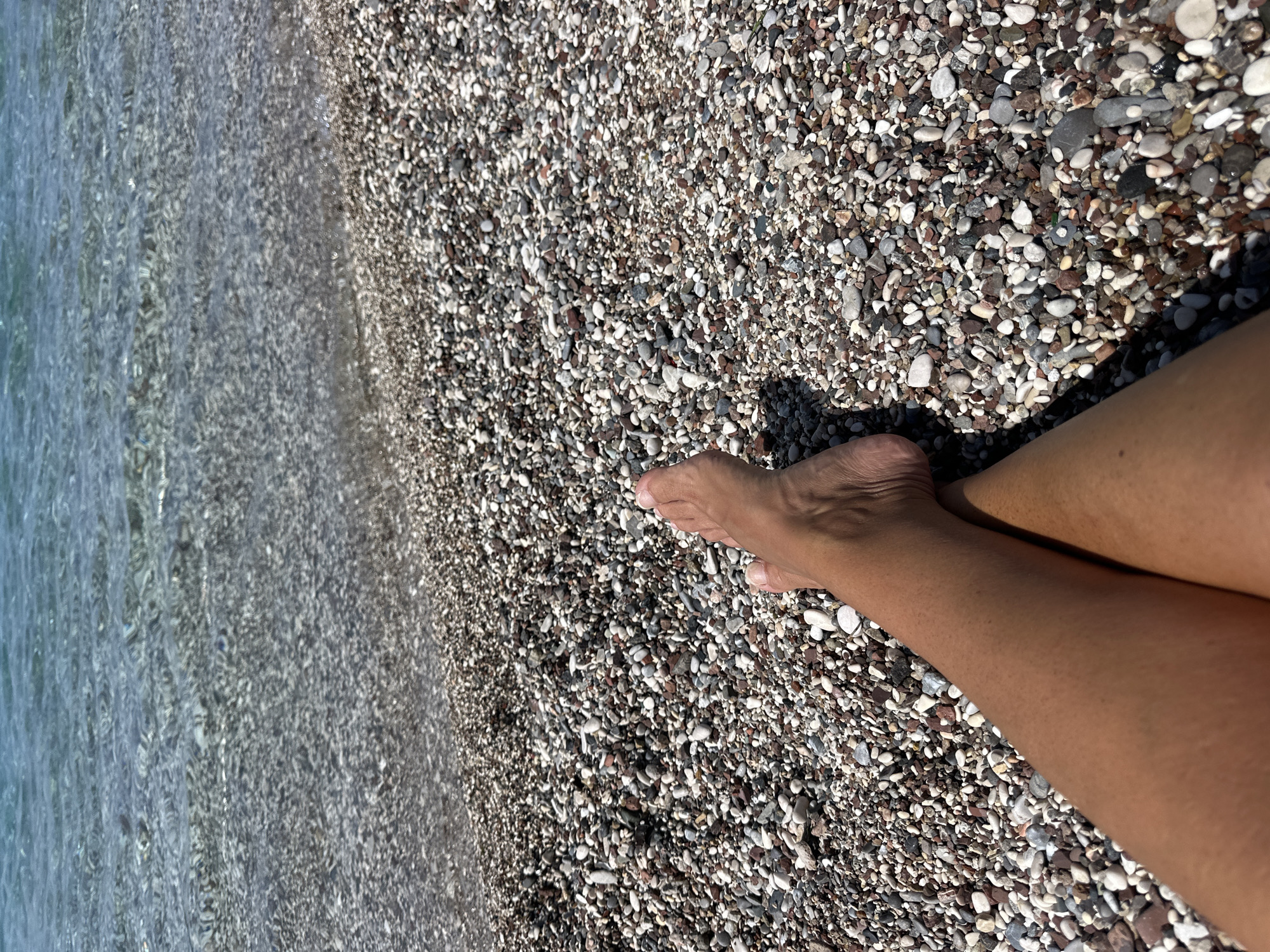 Morning beach scenes captured at Budva's pebble shore