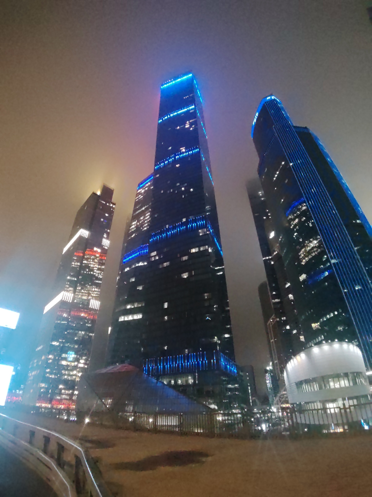 City skyscrapers glowing at night, multiple angles