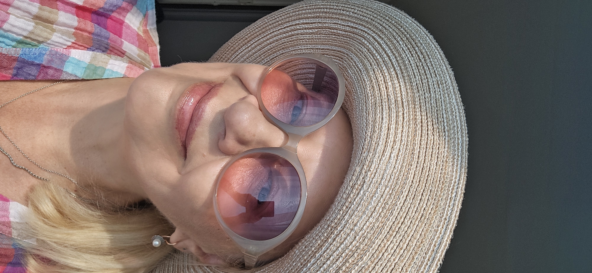 Straw hat and sunglasses selfie paired with eyewear promo graphic