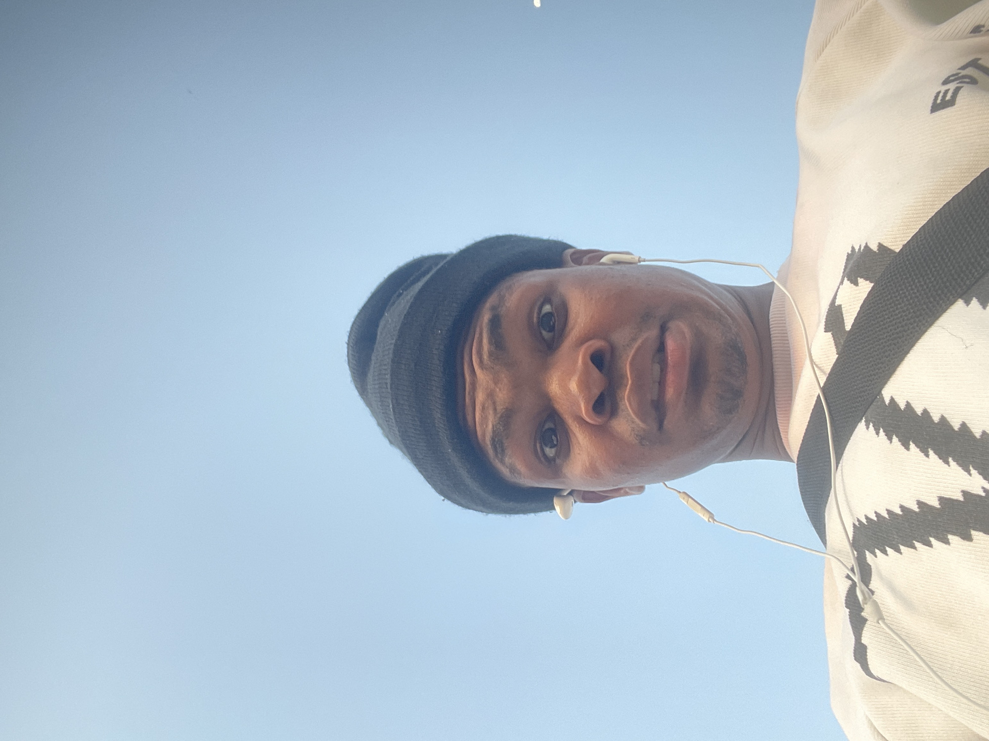 Close-up portrait moment in Ado, Nigeria, open sky backdrop.