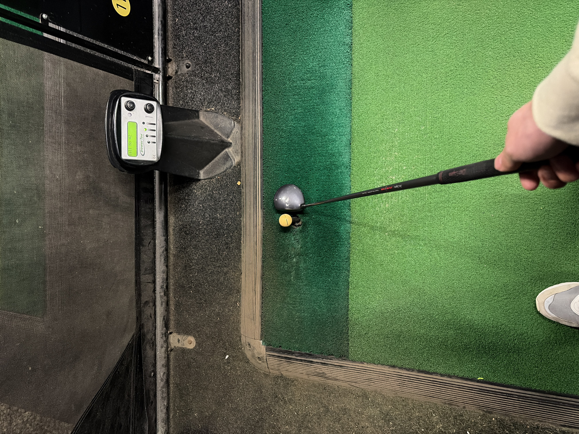 Golfer practices at Suffolk resort using simulators, driving range