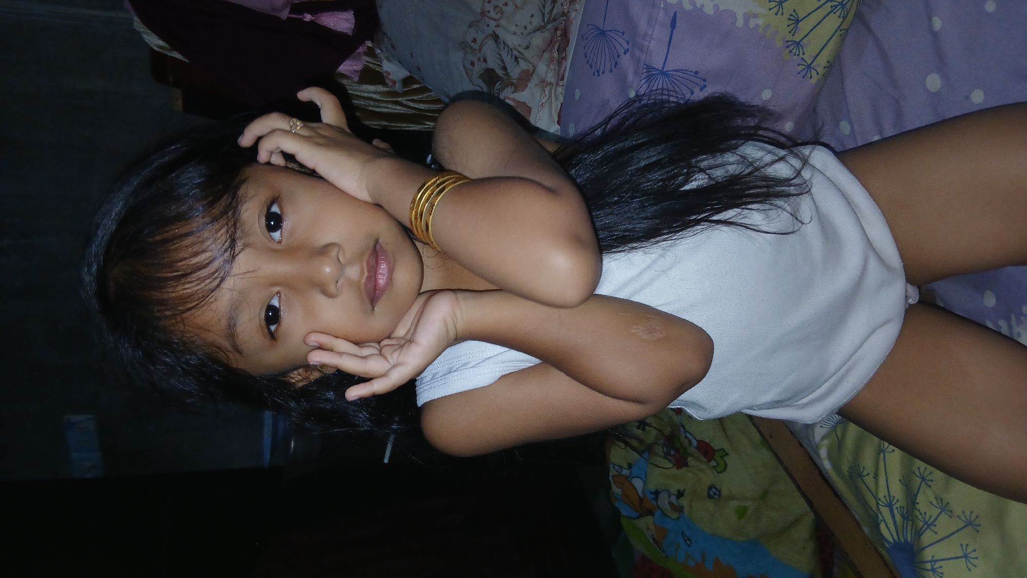 Resting on a bed, gold jewelry visible, Keudejungkagajah