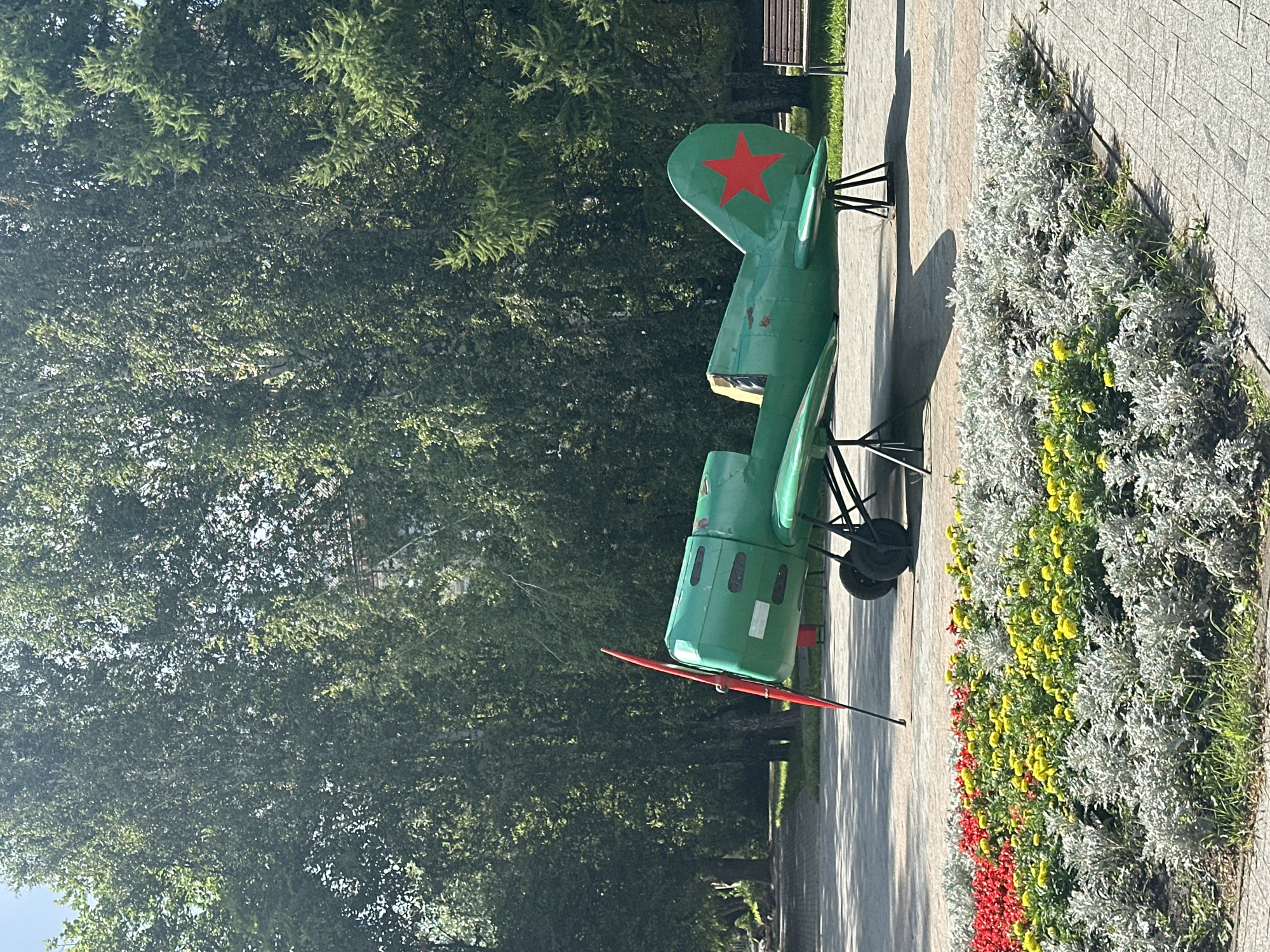 Park stroll past a display plane, cell tower, and street art
