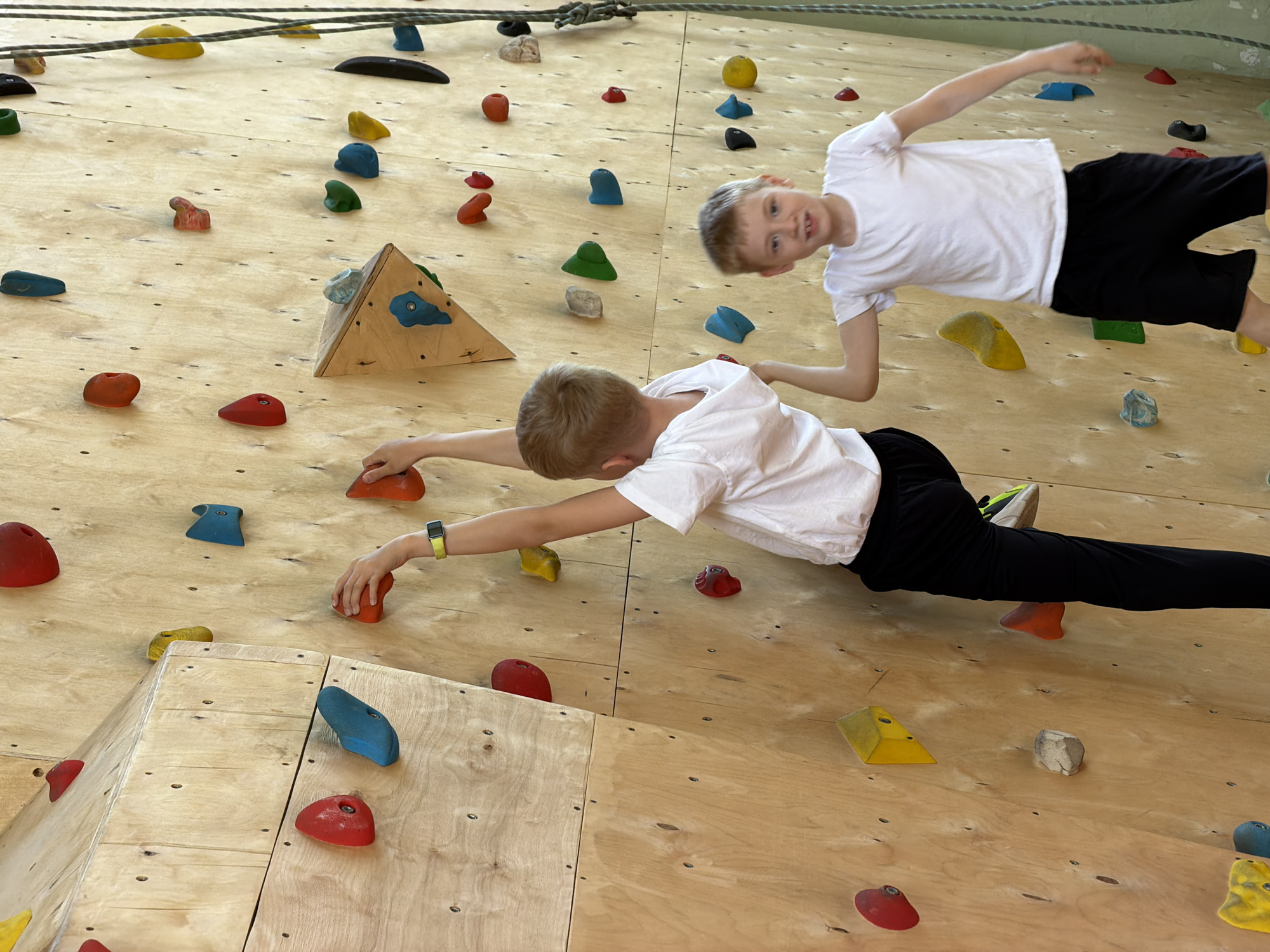Children climb indoor wall at Izhevsk climbing facility