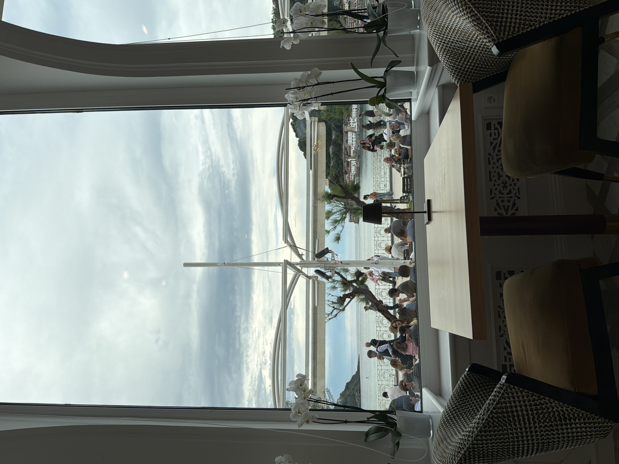 Elderly couple dines overlooking La Concha beach, San Sebastián