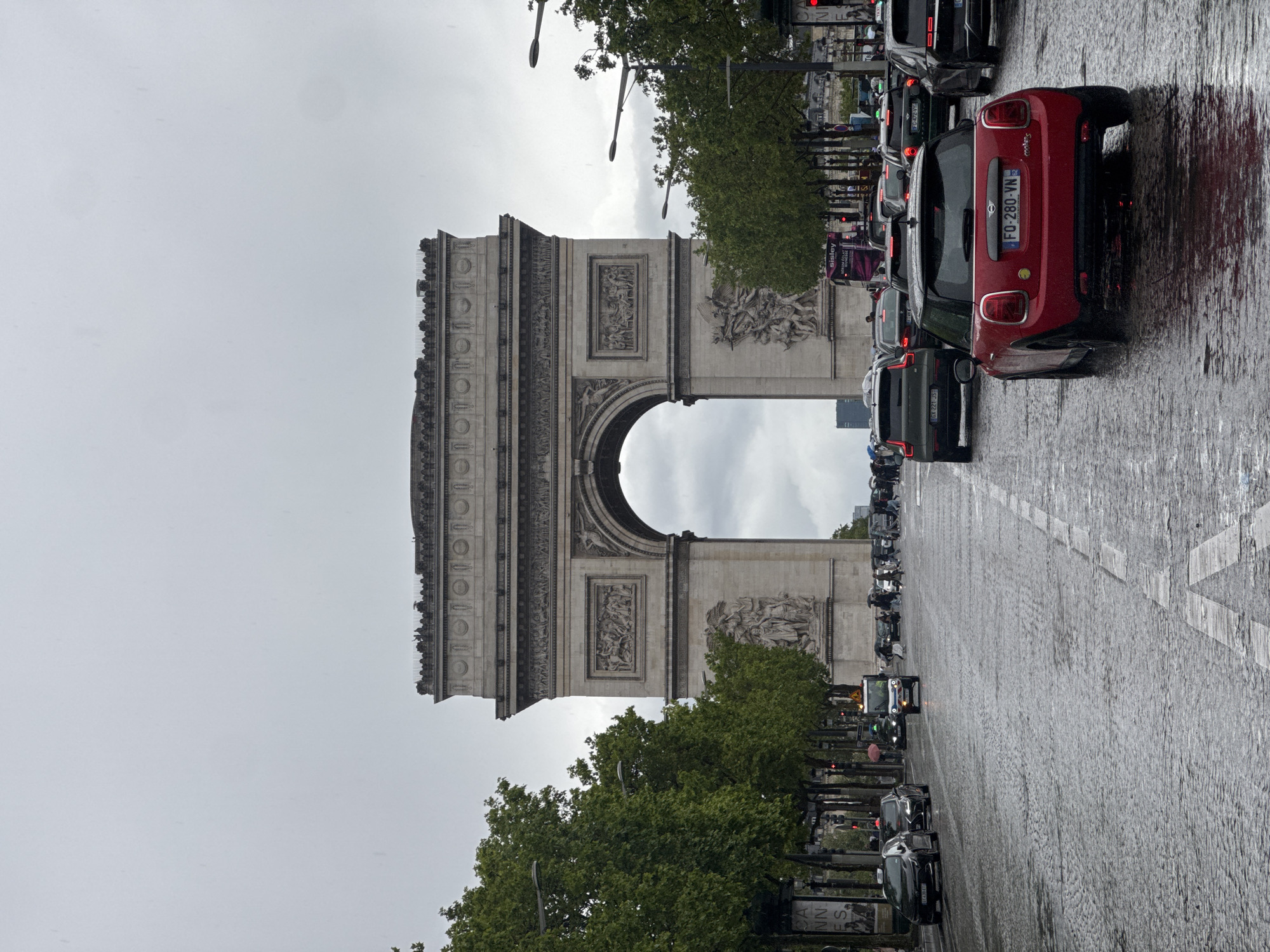 Wet streets and heavy traffic near Arc de Triomphe