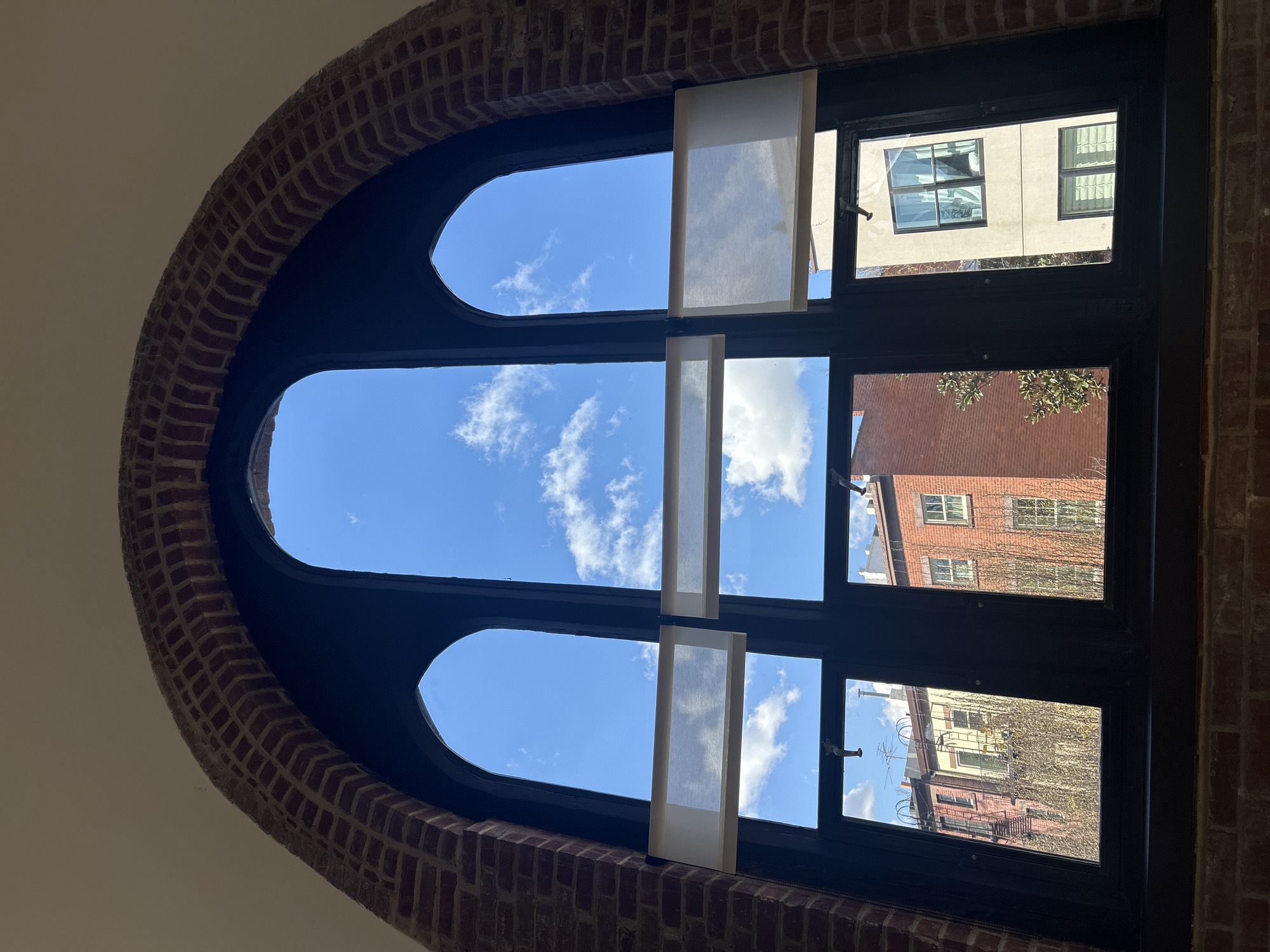 Arched stained glass window observed in NYC building