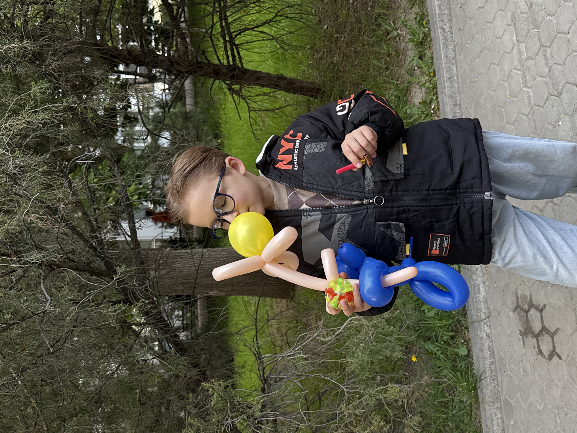 Boy in glasses observed on sidewalk, additional media unprocessed