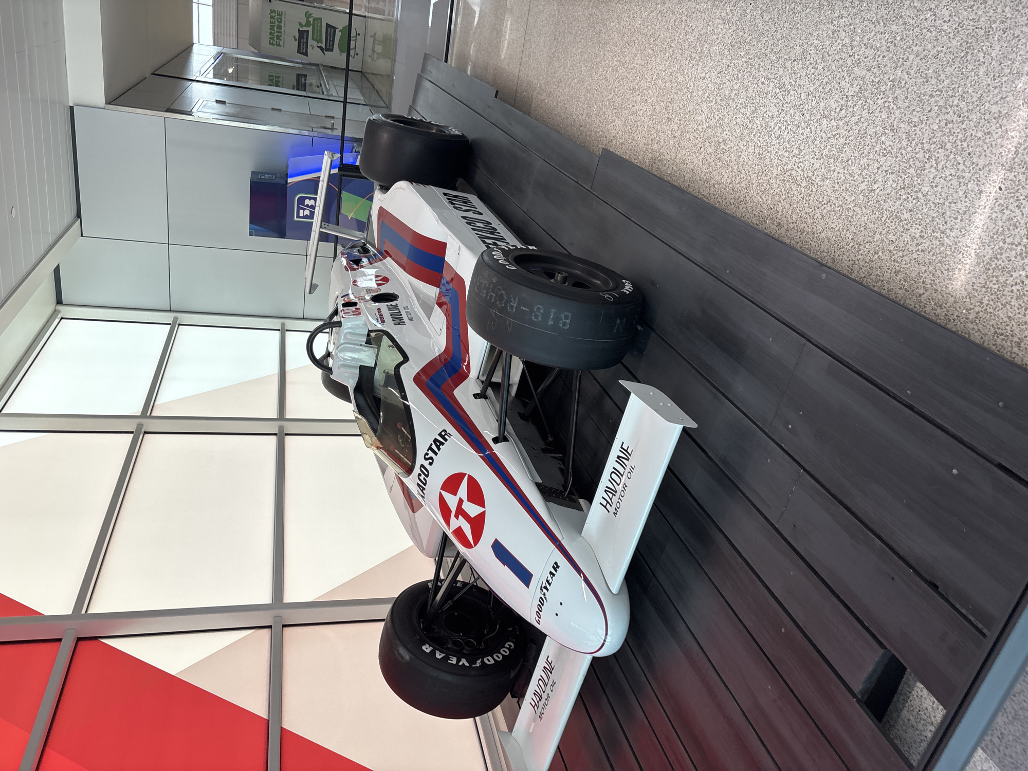 Vintage race car with sponsor logos displayed in Indianapolis