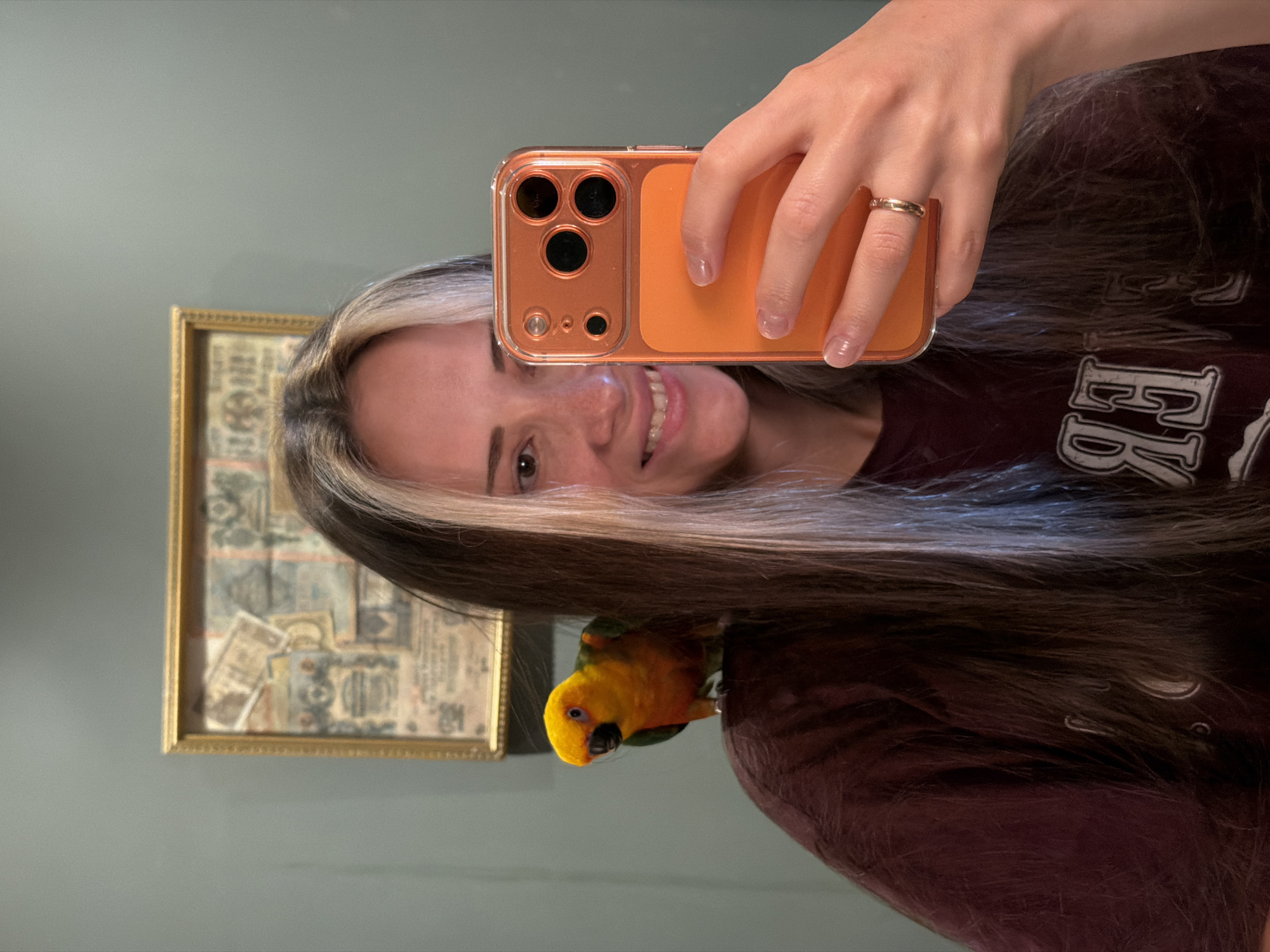 Person poses with colorful parrot in Khimki home