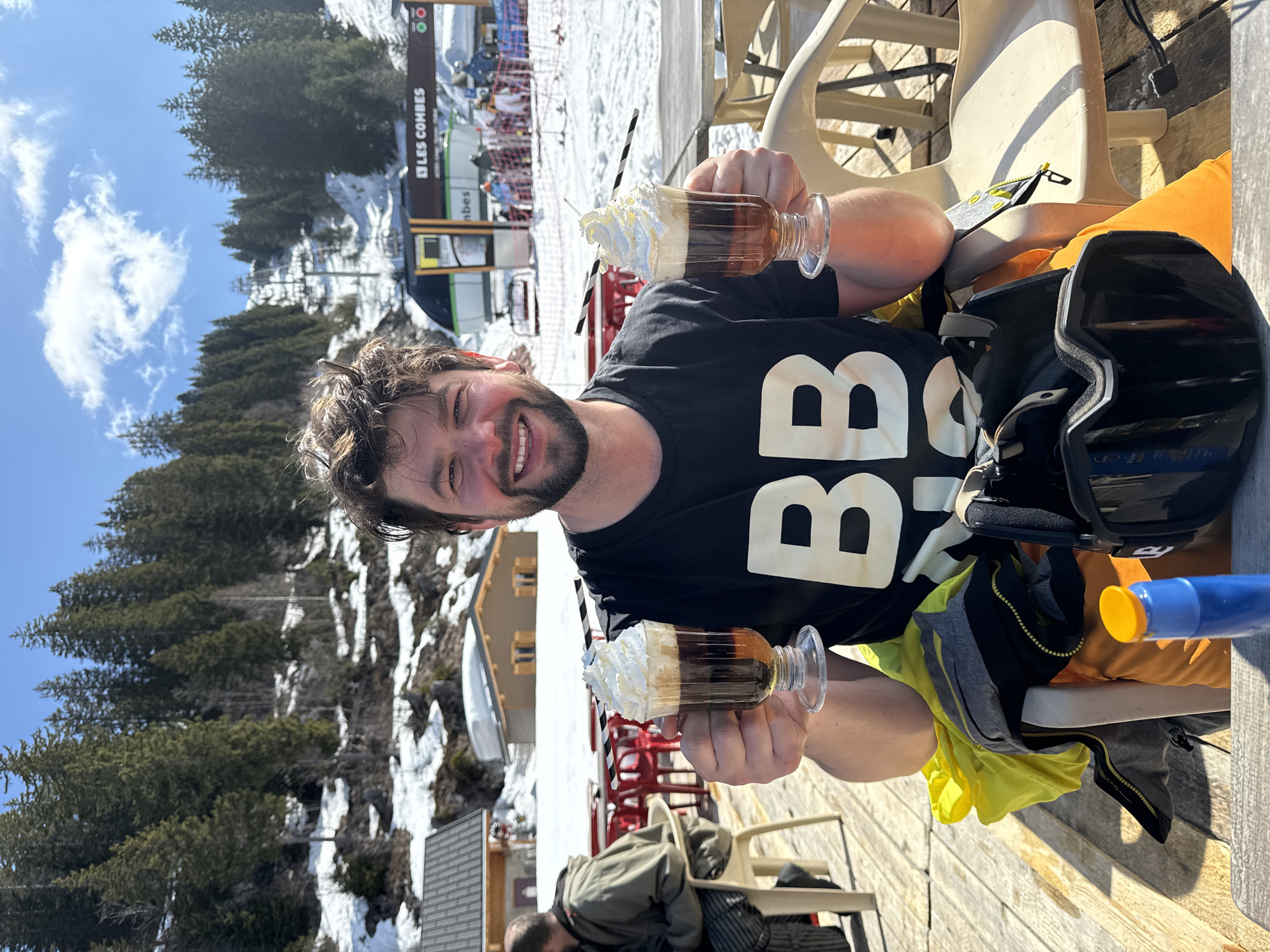 Man enjoys layered drinks in Châtel, France