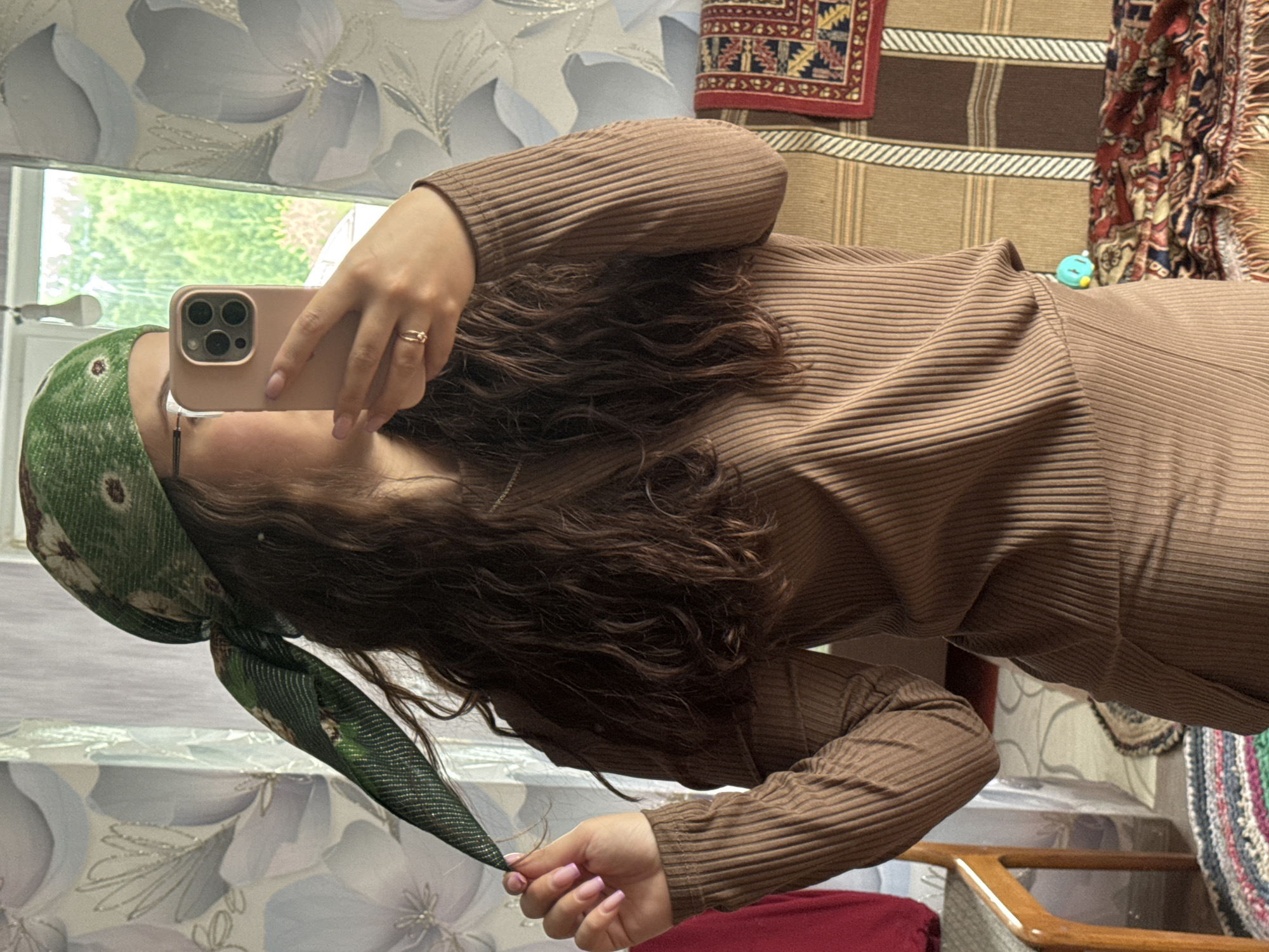 Woman takes selfies in room in Nizhnyaya Gar', Russia