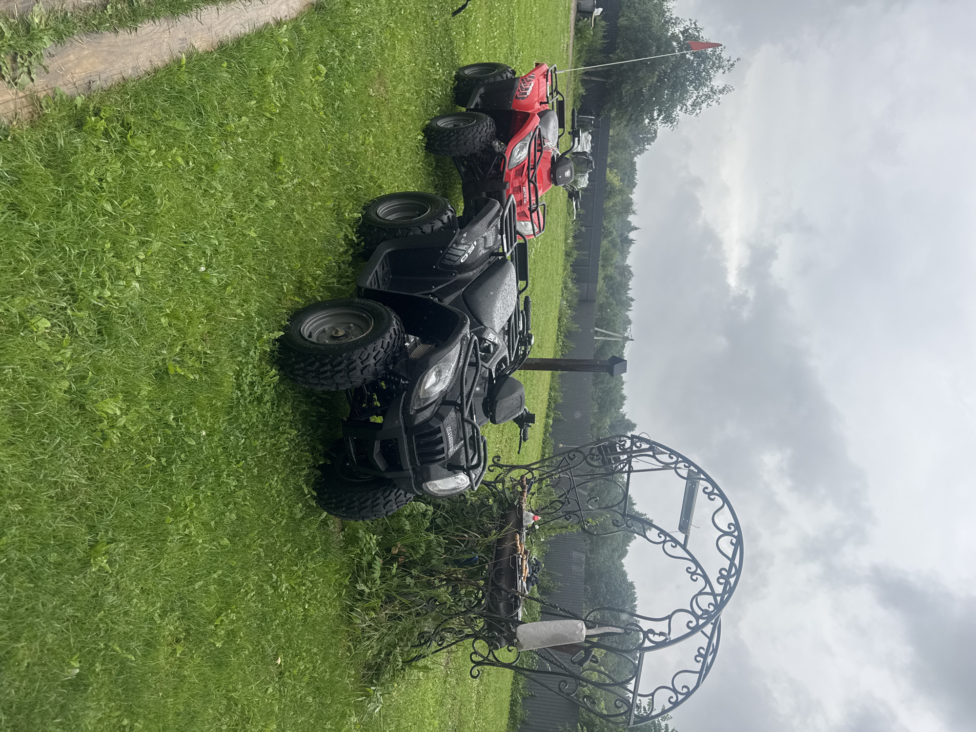 Two ATVs parked on a lawn in rural Russia