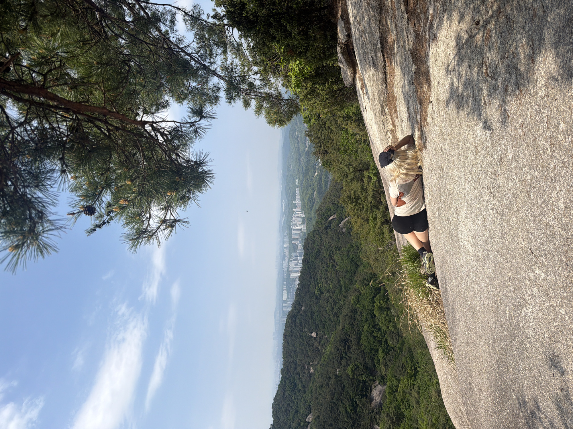Woman stands on granite rocks at Seoul's Bukhansan National Park