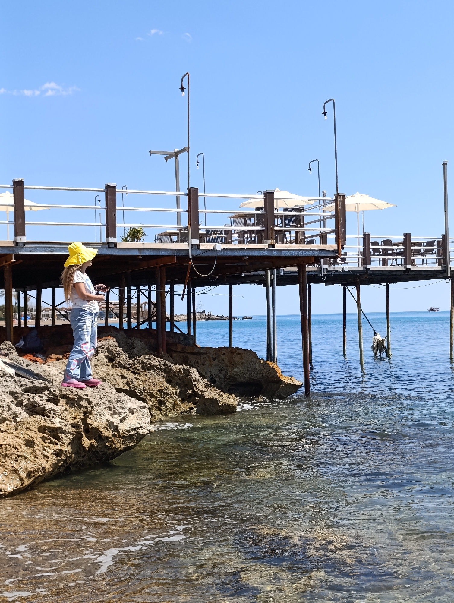 Woman enjoys morning at scenic Antalya pebble beach