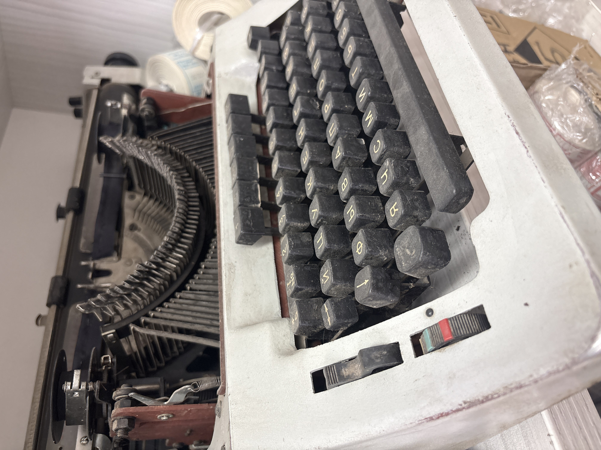 Woman documents vintage typewriter workspace in Russian office