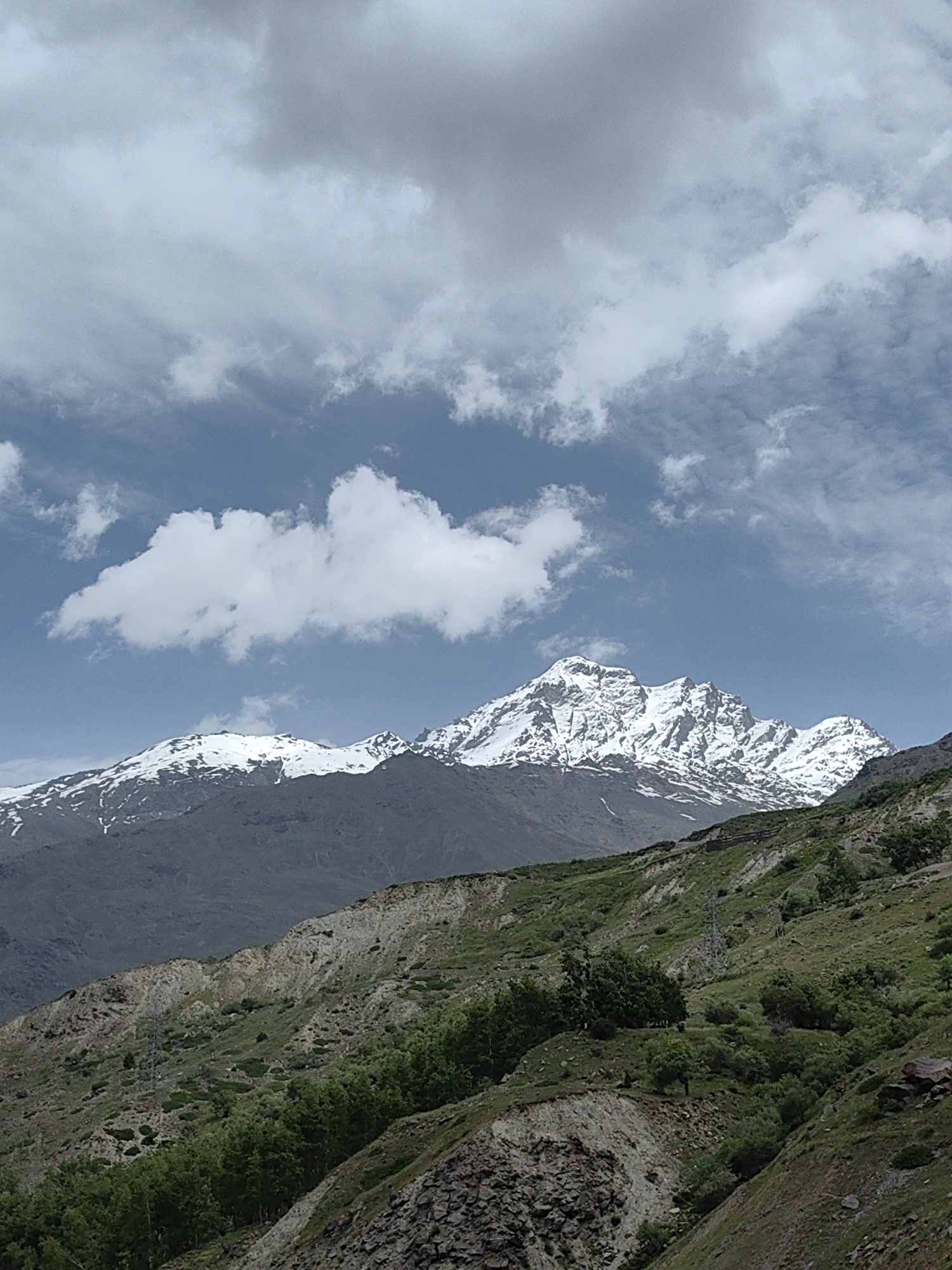 Sissu's rugged river valley under stormy mountain skies