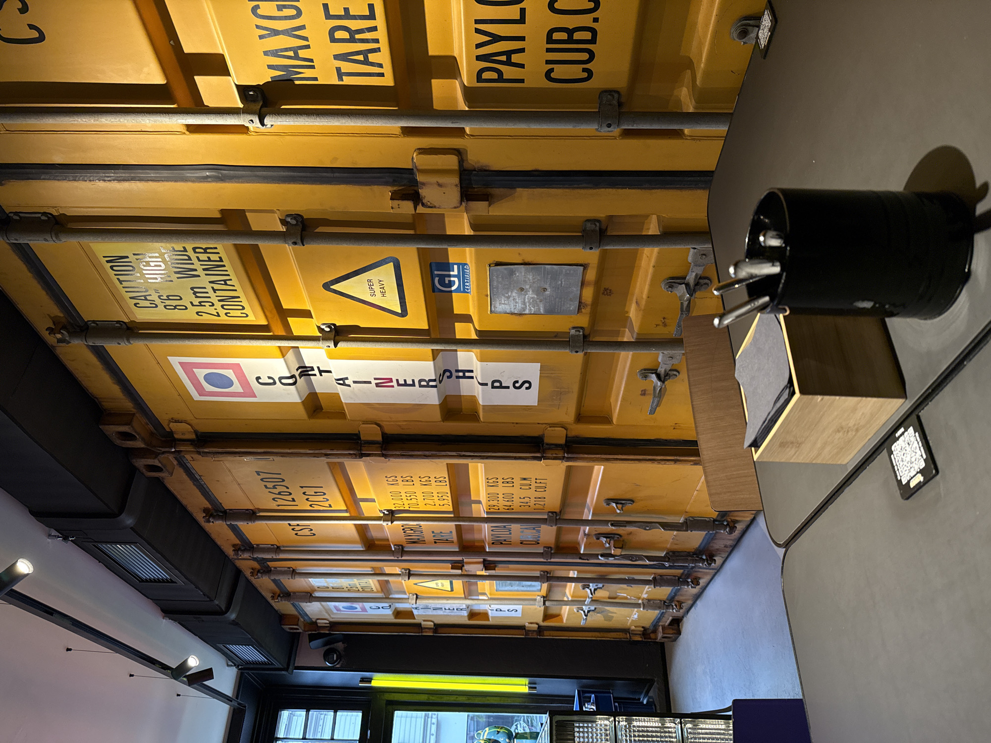 Modern Riga cafe features shipping container ceiling, basketball wall displays