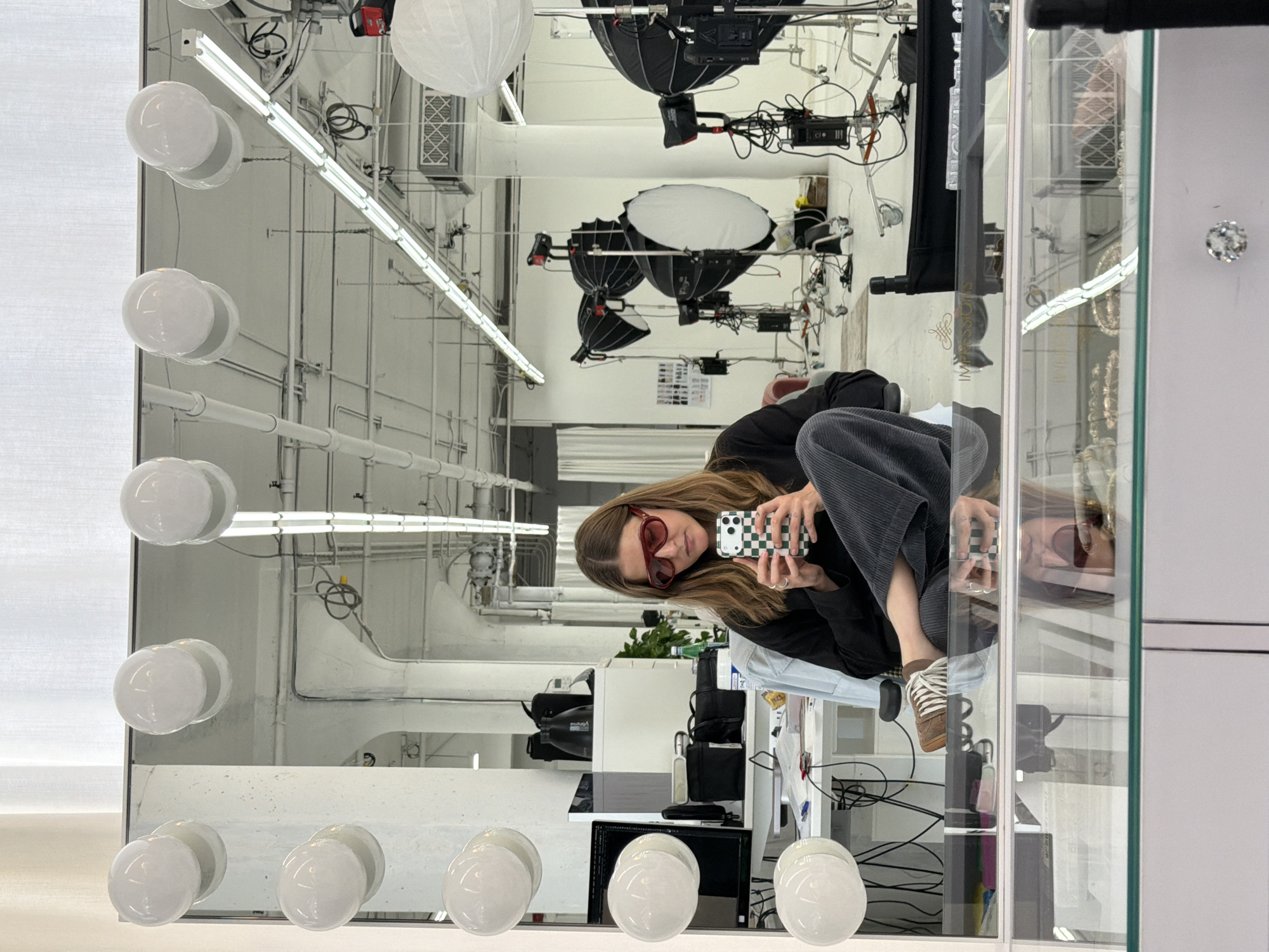 Person documents selfies in Los Angeles photography studio
