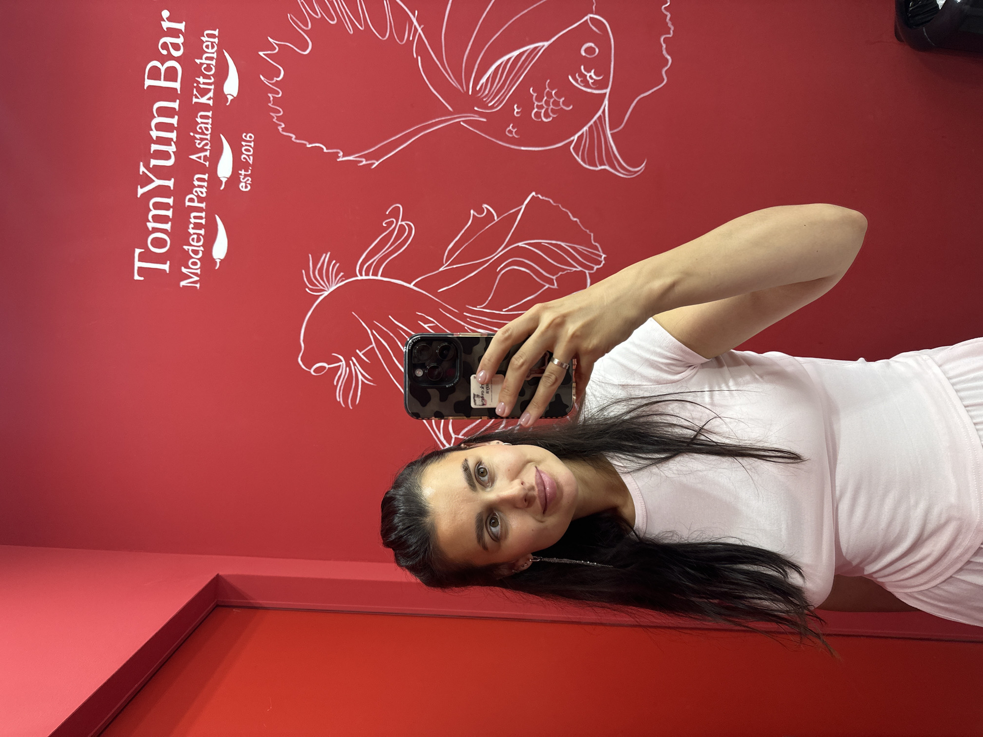 Inside a colorful Perm restaurant with angel wings and red walls
