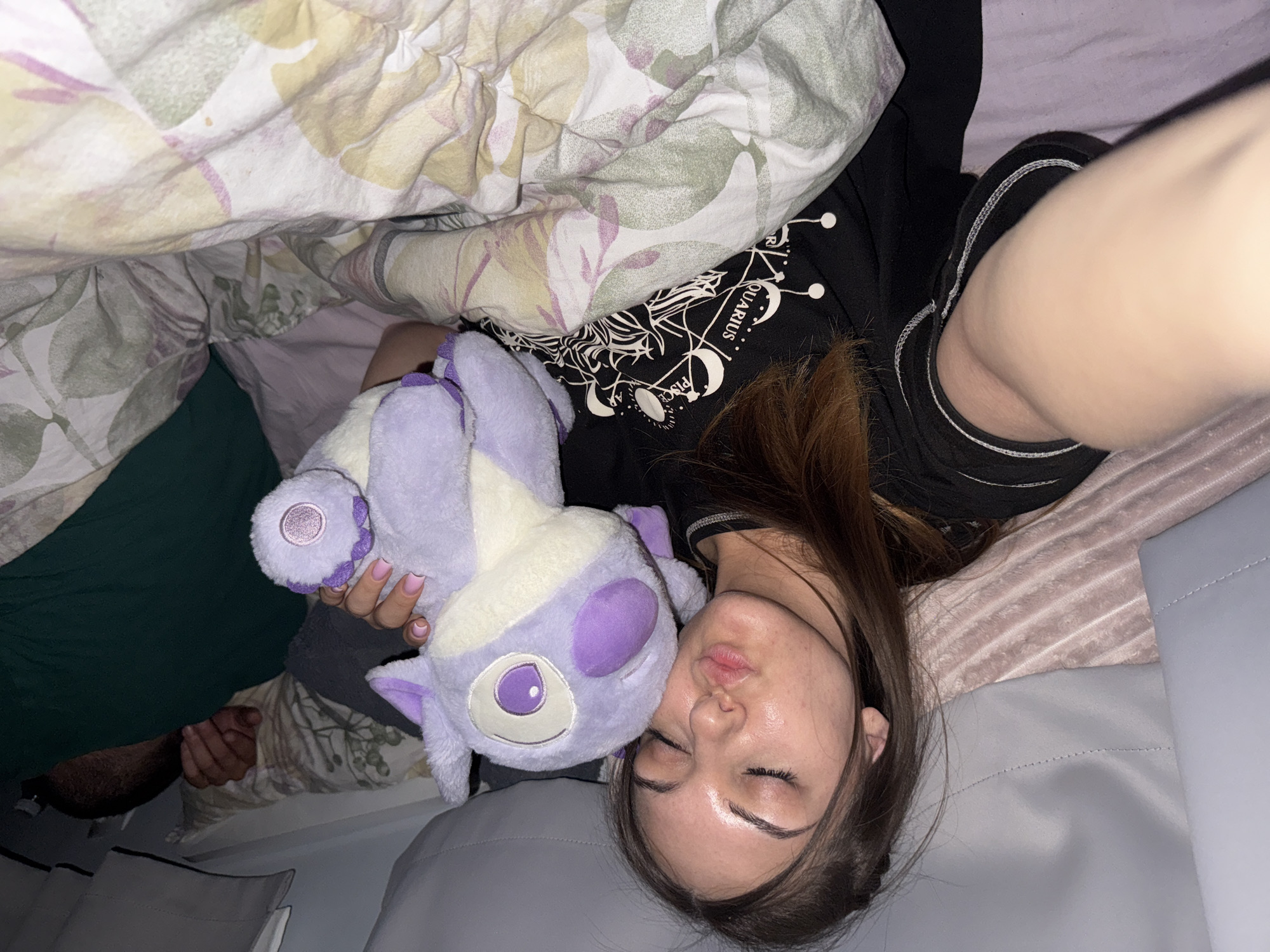 Woman rests with plush toy in Sofia bedroom