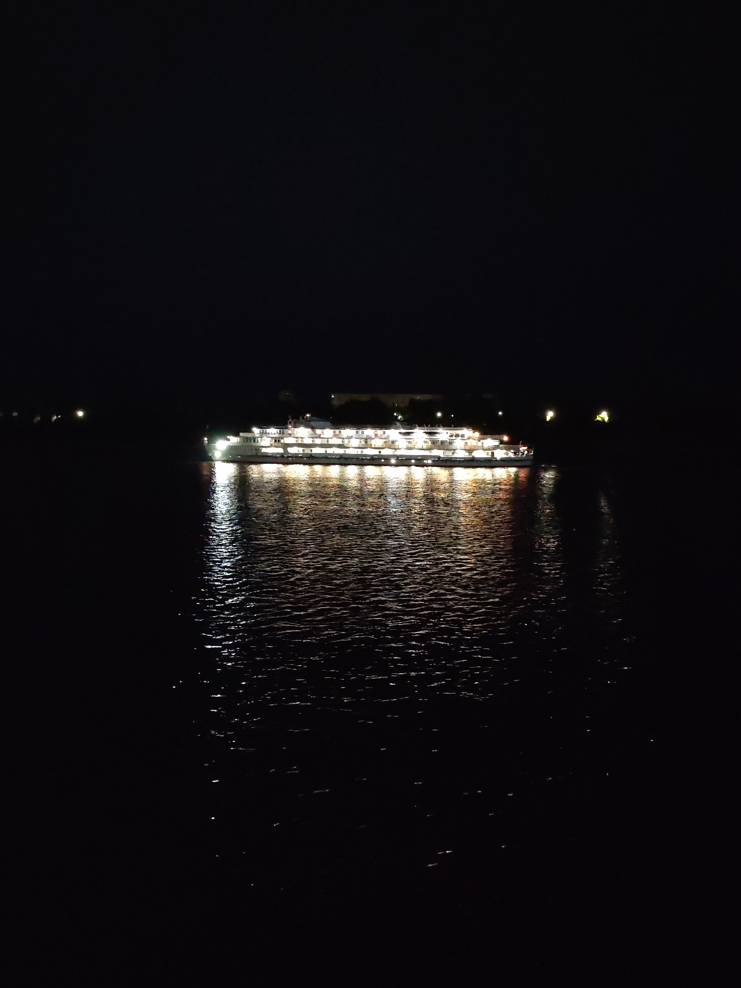 Night cruise on a lit riverboat near Bol'shie Mkhi, Russia
