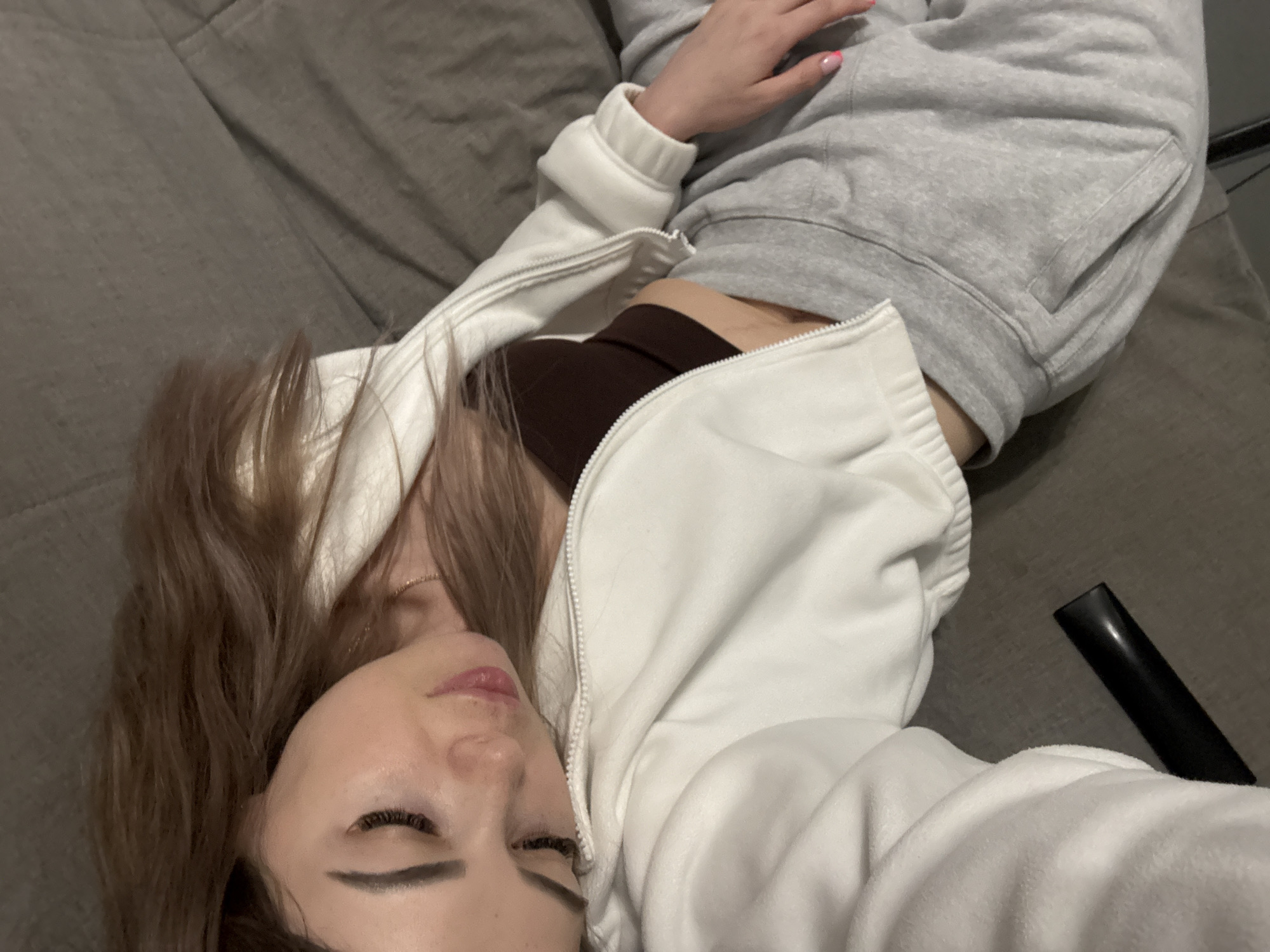 Casual photographs capture woman resting, raised hand against overcast sky