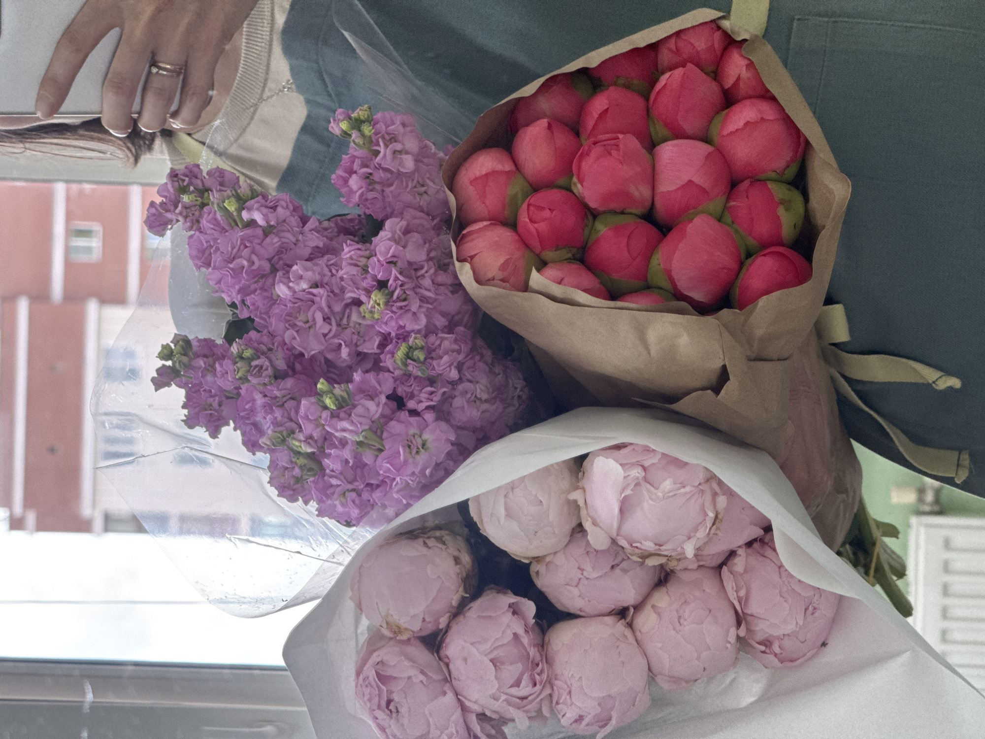 Woman documents flower bouquet collection in Izhevsk shop