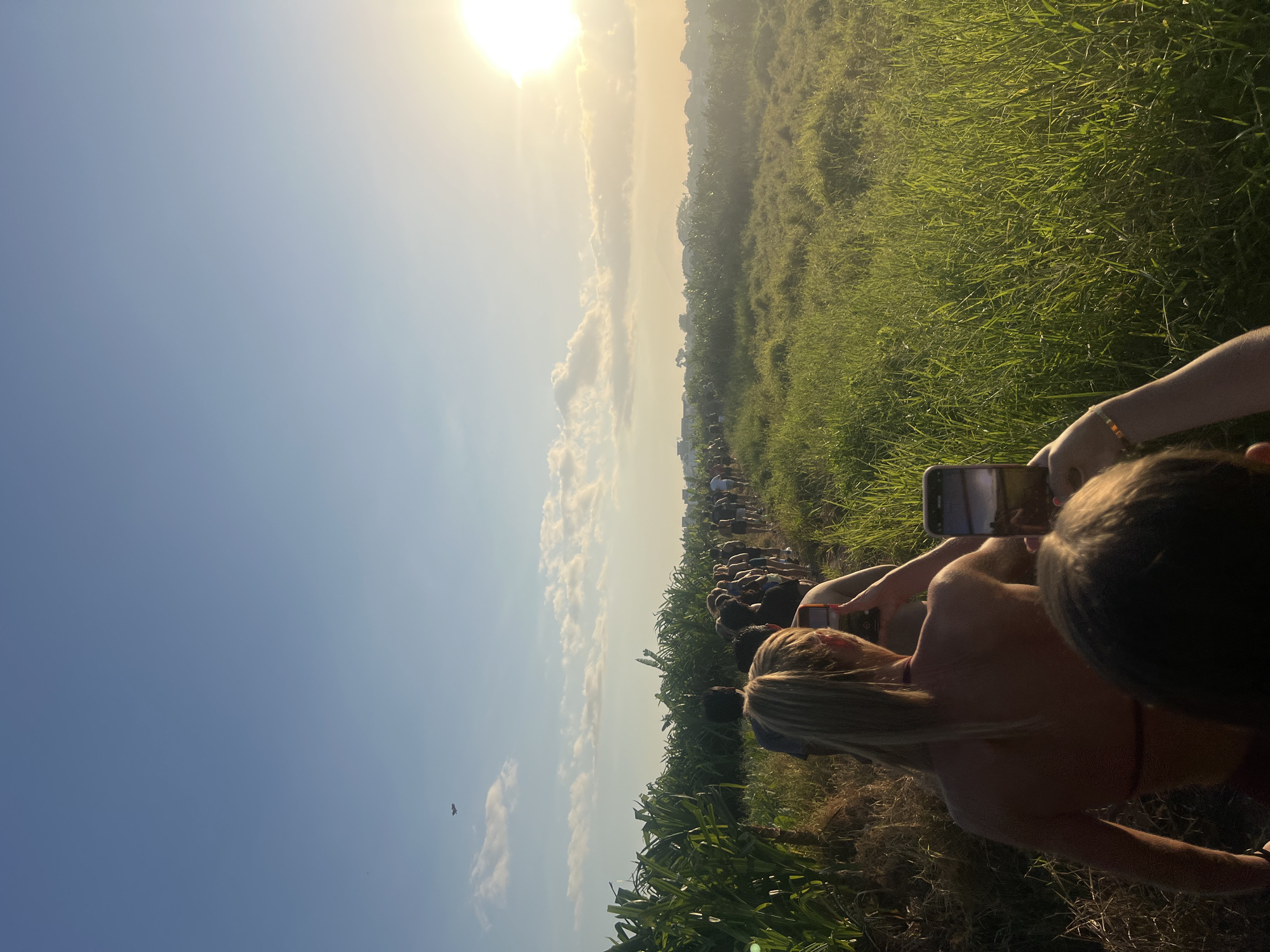 Group moves single-file through Mengwi fields at sunset