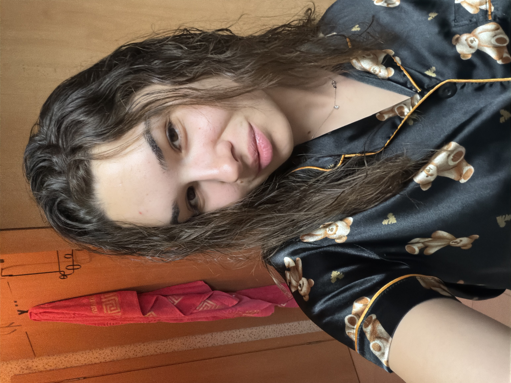 Woman takes playful bedroom selfies in teddy bear pajamas