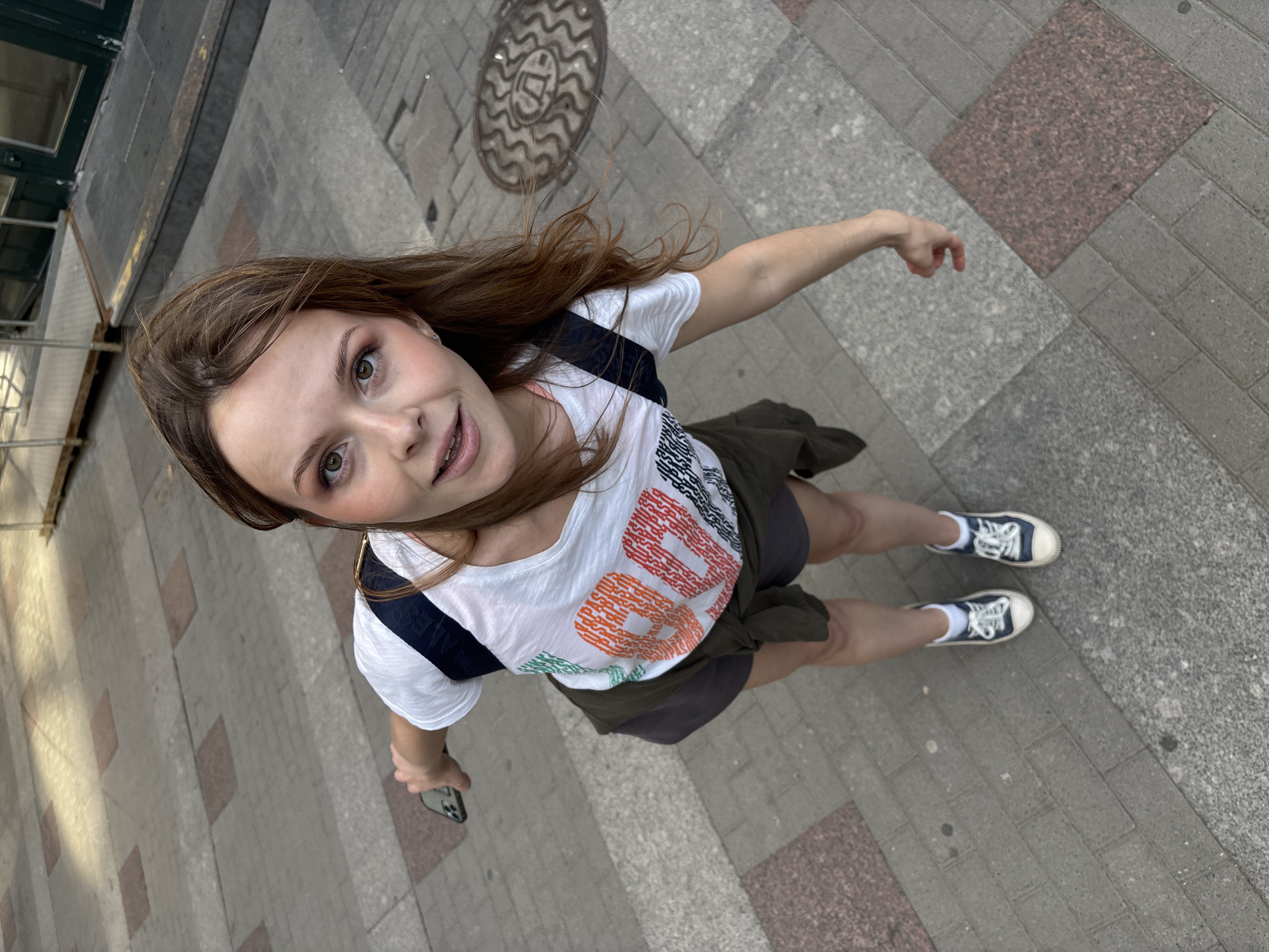 Young women photograph themselves near Saint Petersburg shopping complex