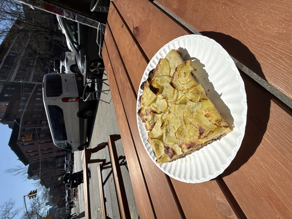 Customer enjoys potato tart at Impasto restaurant in NYC