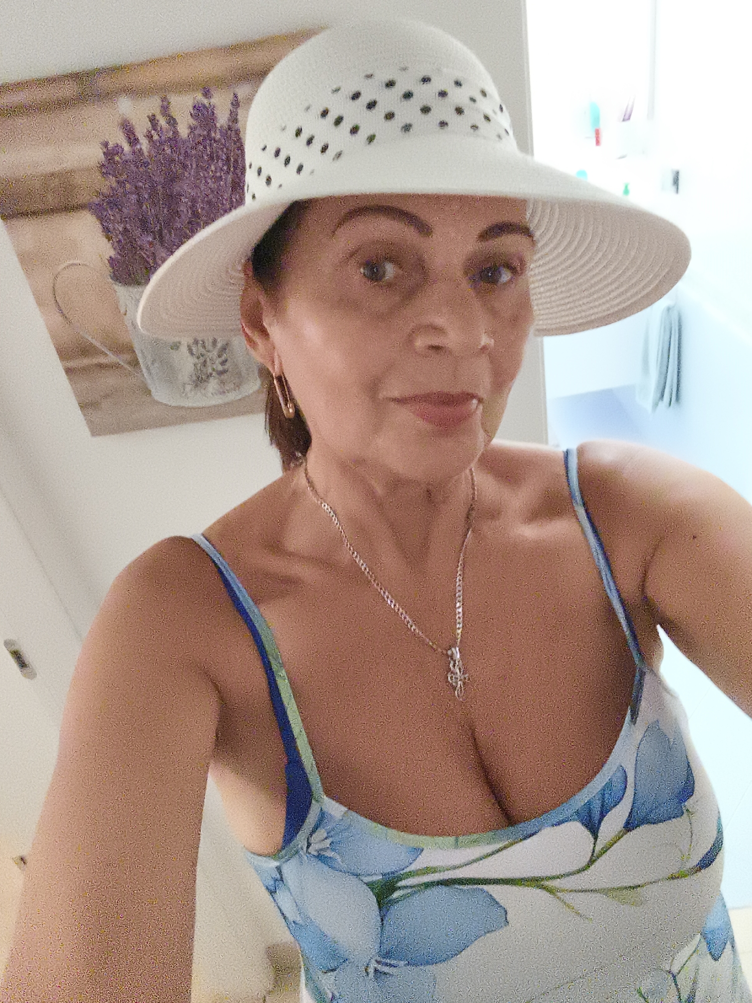 Summery outfit with floral dress and polka-dot hat in Livorno
