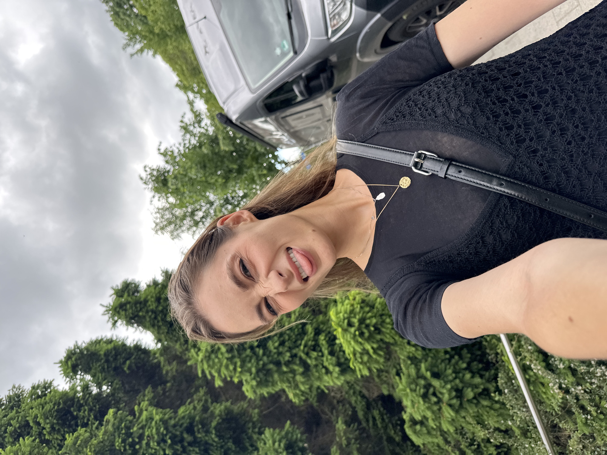 Woman poses for photos on Kiel sidewalk