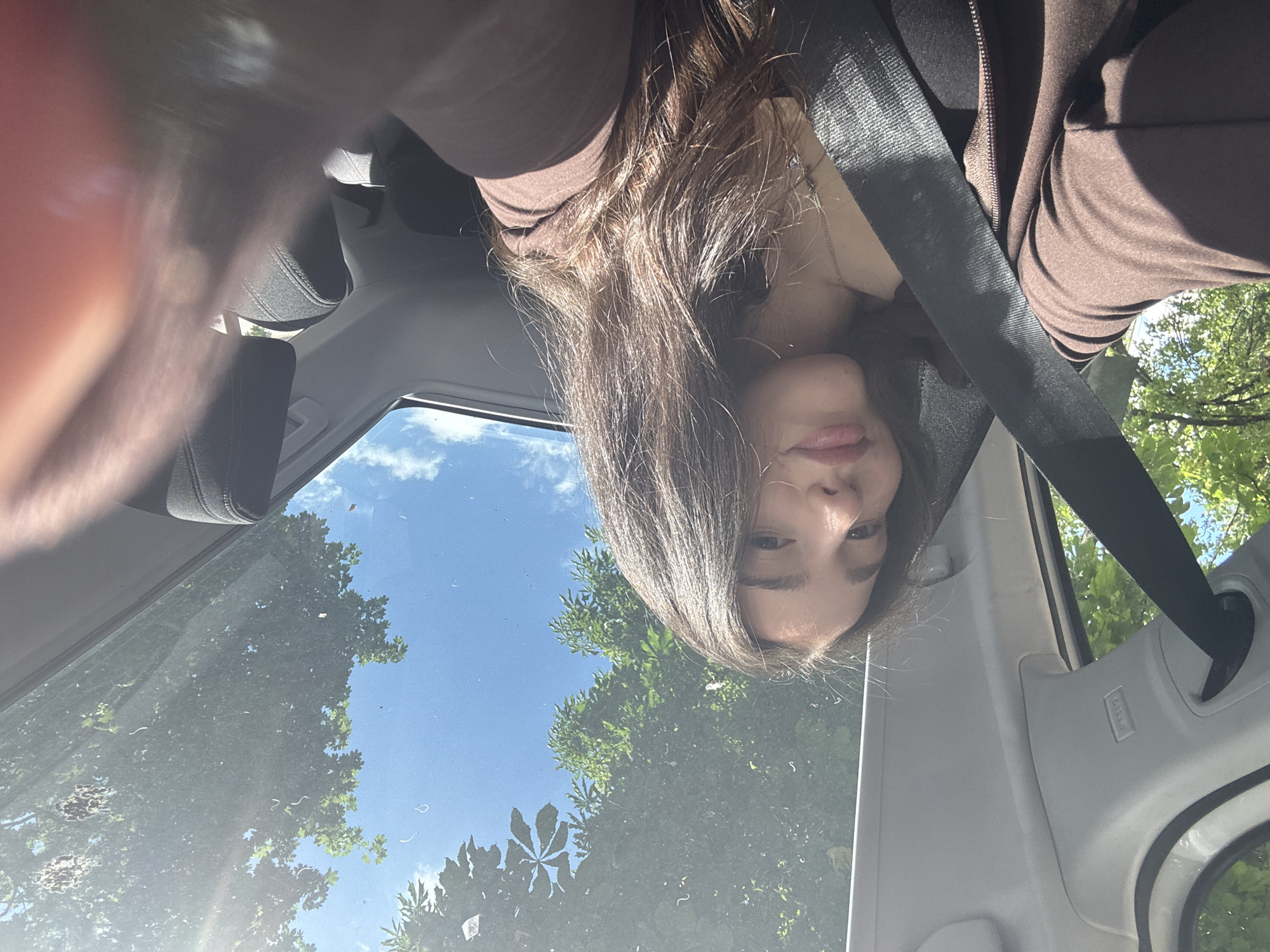 Woman takes selfie in car driver's seat