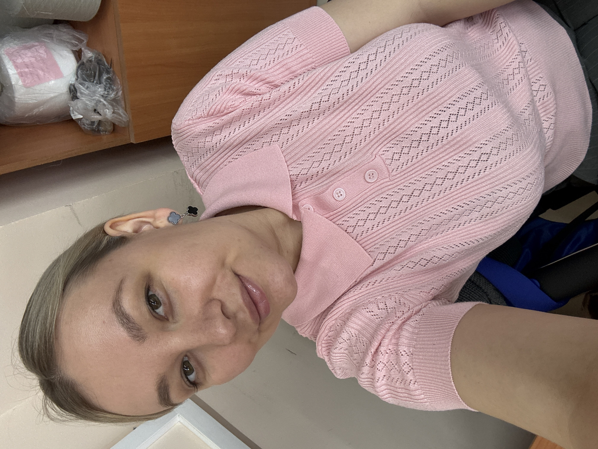 Woman takes selfie in pink knit top in Chaikovsky