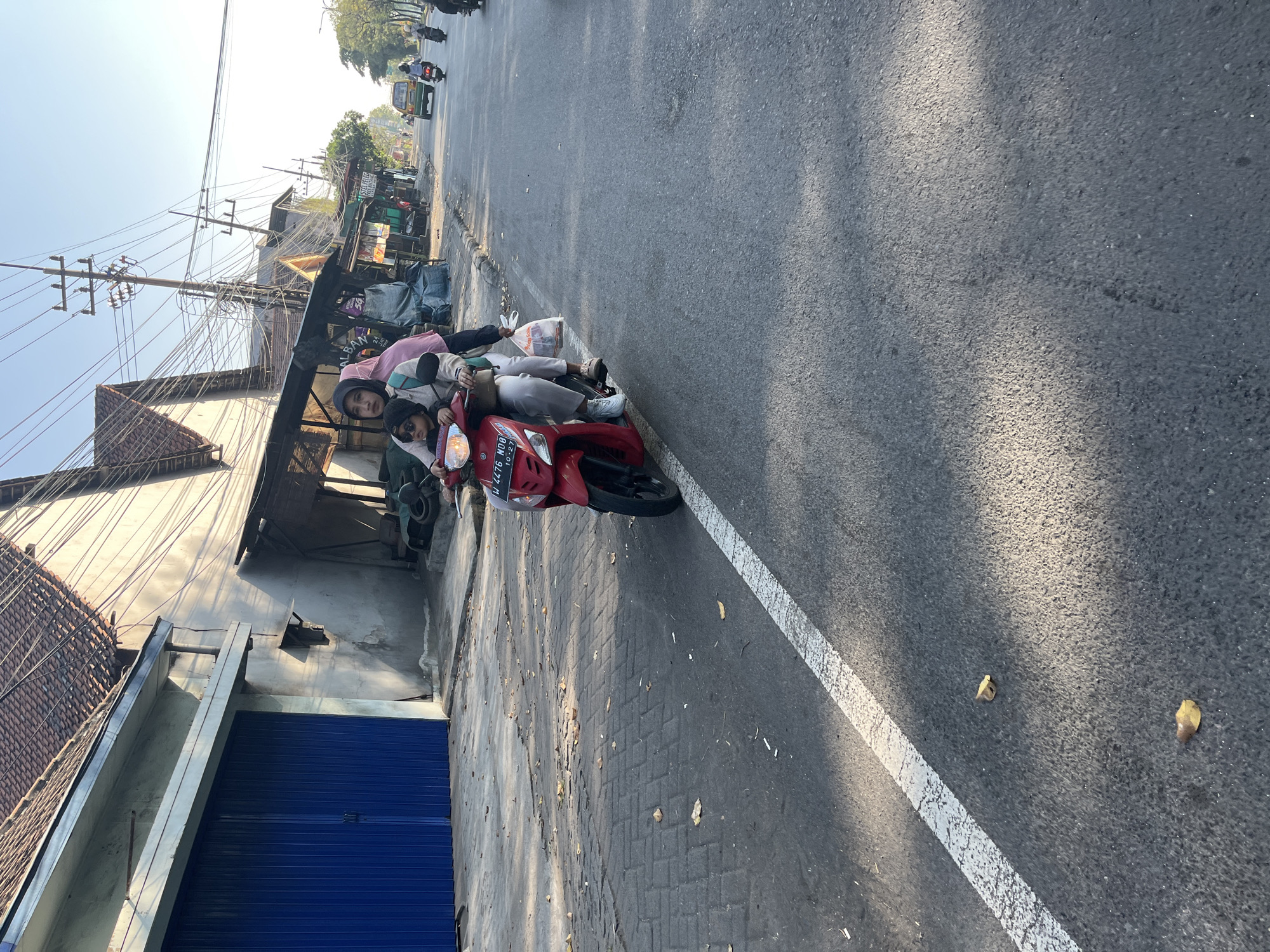 Morning street life along a busy road in Kludan, Indonesia