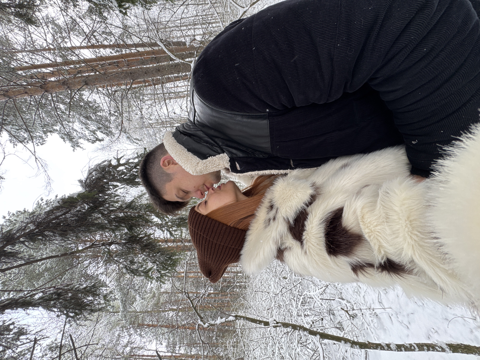 Couple shares intimate moment in snowy Chaikovsky forest