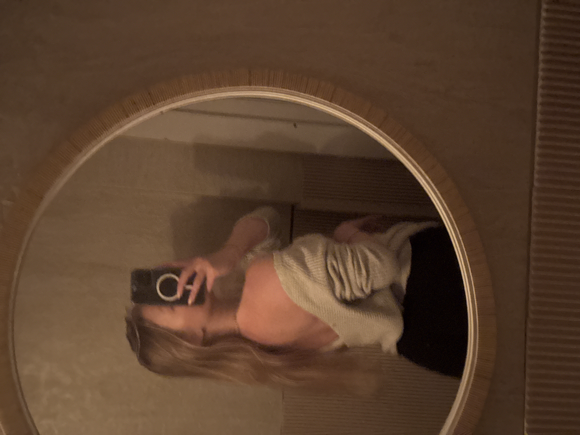 Person Takes Selfie in Round Mirror in Herzliya