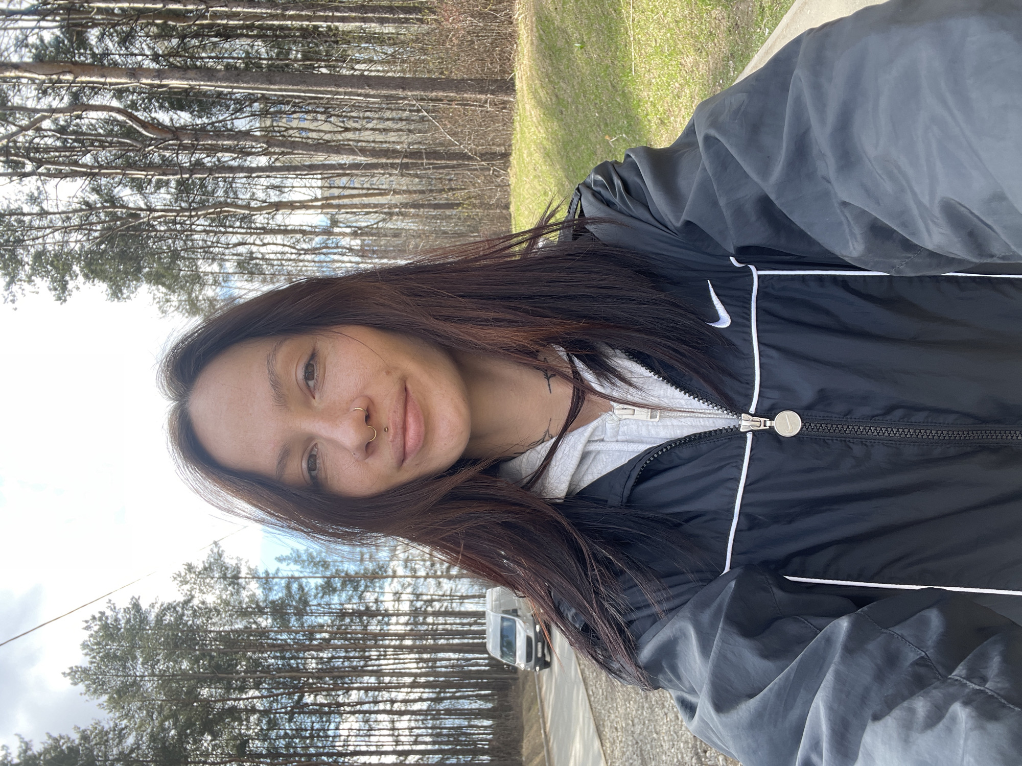 Woman takes selfie under partly cloudy skies in Izhevsk