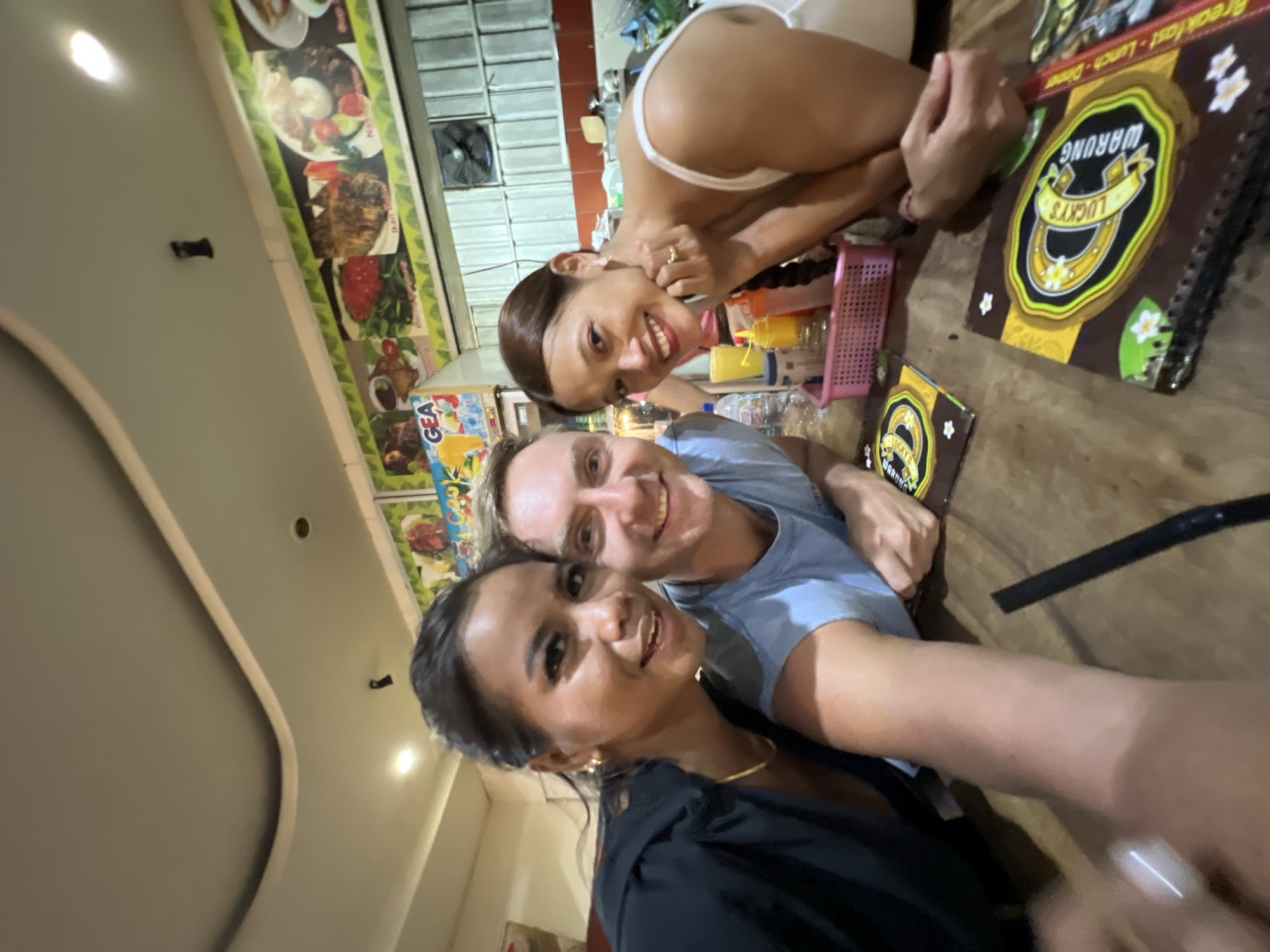 Three friends take selfie at Kuta restaurant