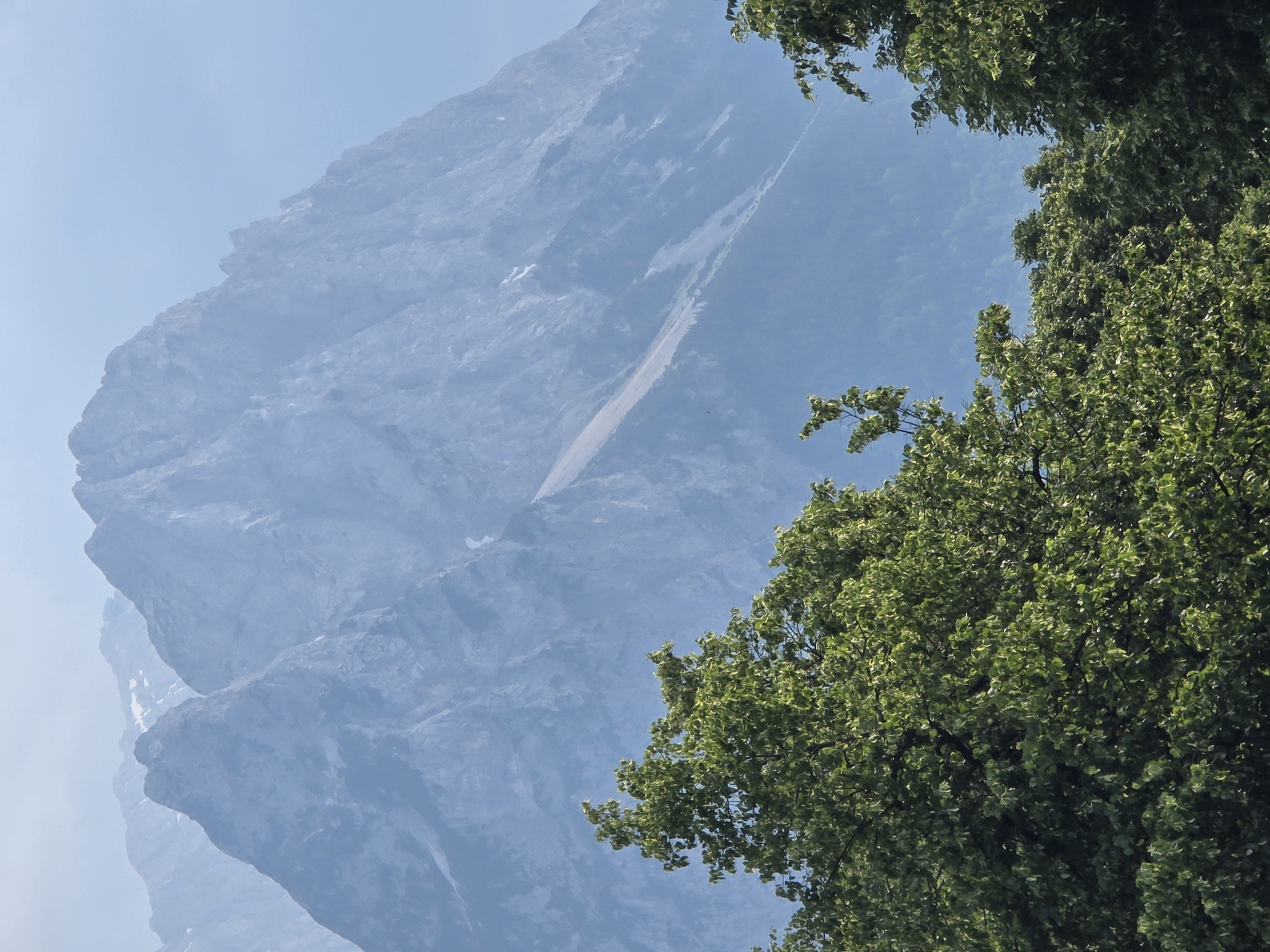 Alpine town streets framed by misty, snow-patched peaks