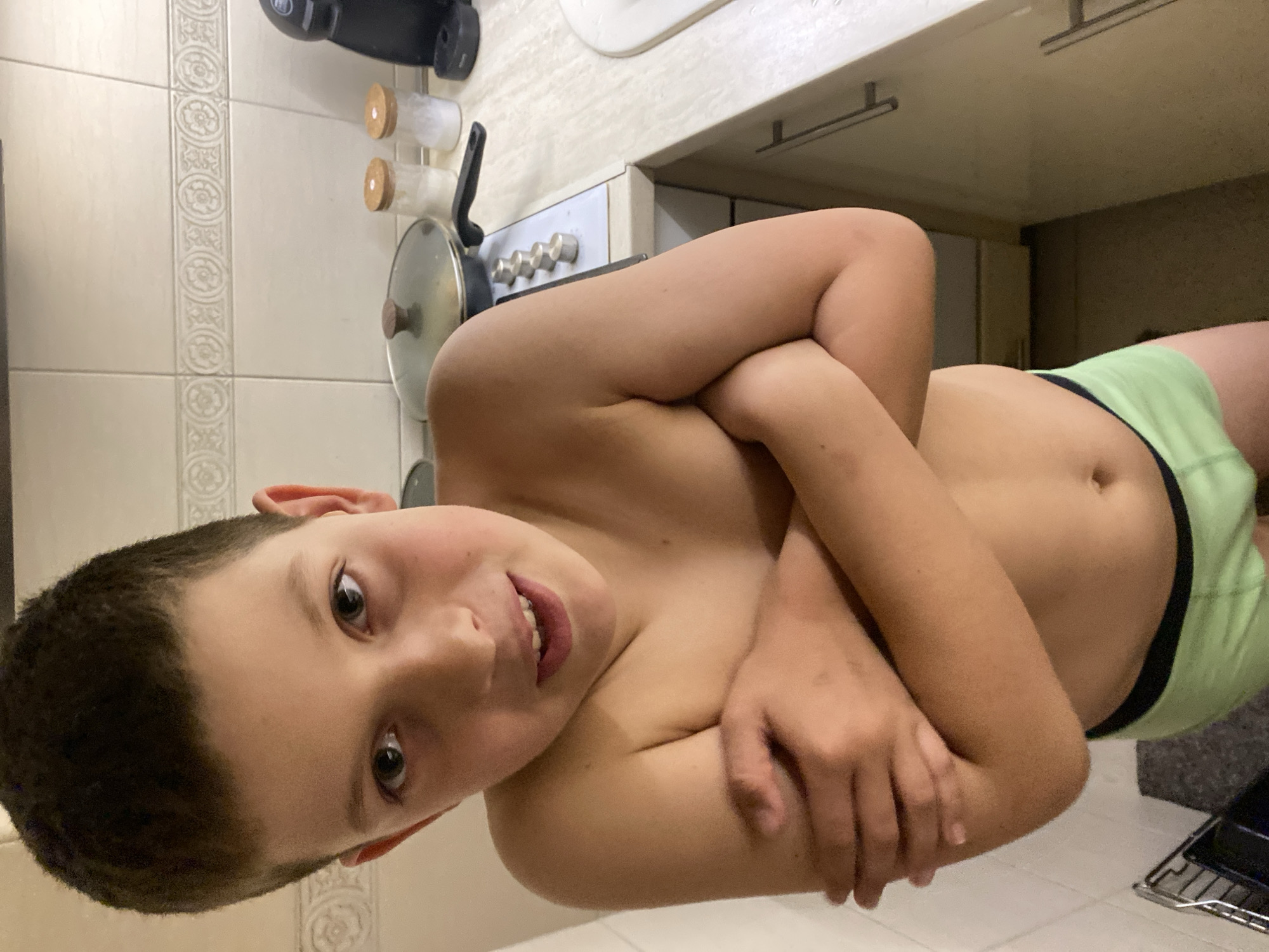 Boy drinks, plays with kitchen items in Budva home