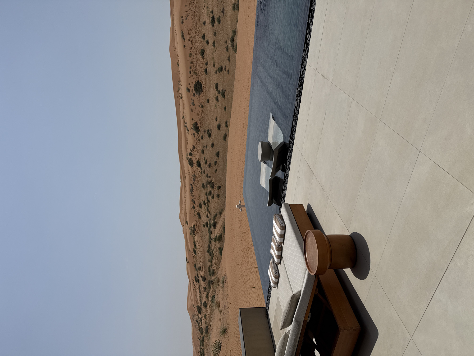 Luxury resort infinity pool and lounge overlooking RAK desert